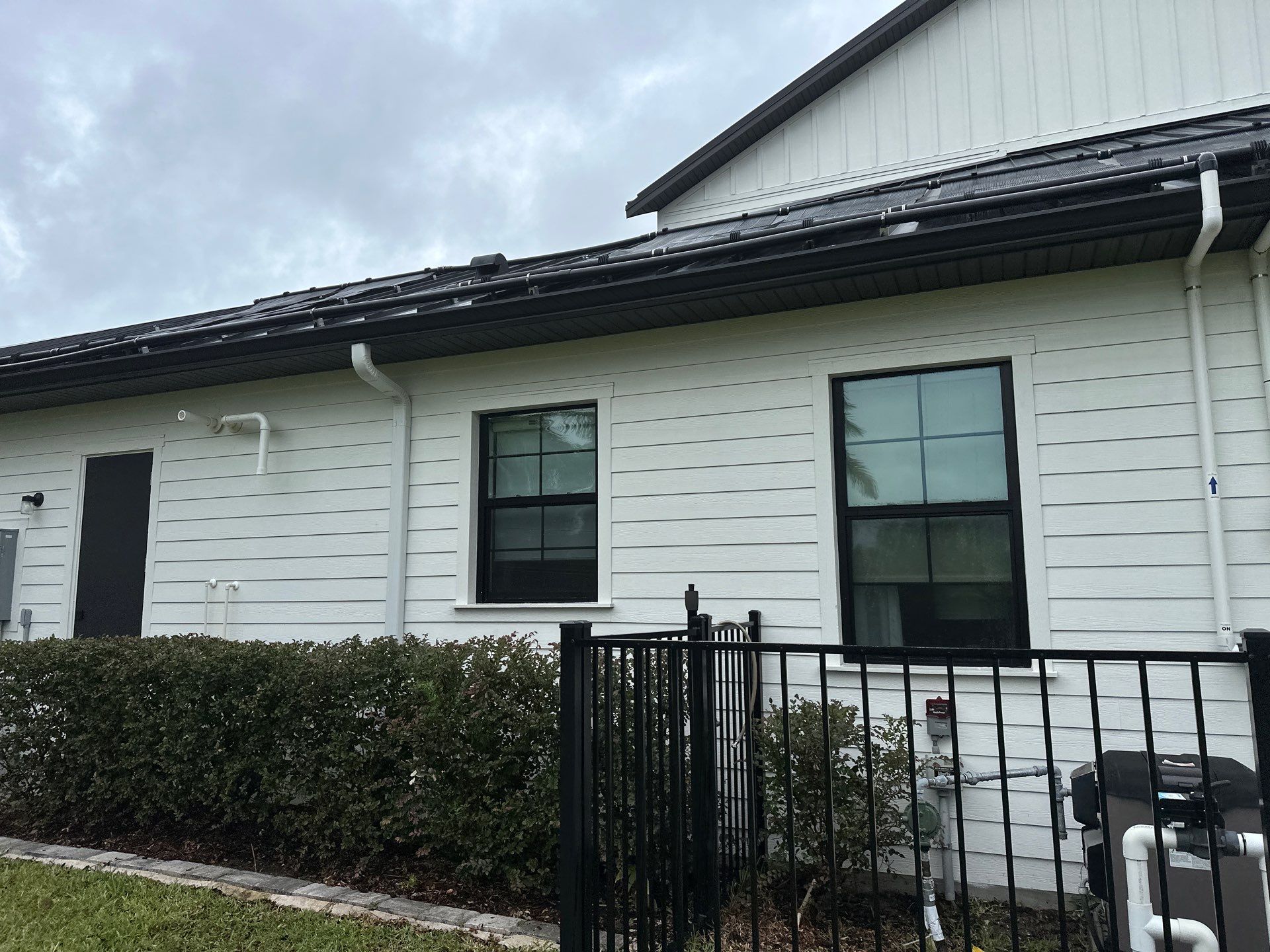 Complete Two-Story House Wash and Driveway Cleaning in Winding River Community, Bradenton, FL by Sunshine AquaWash