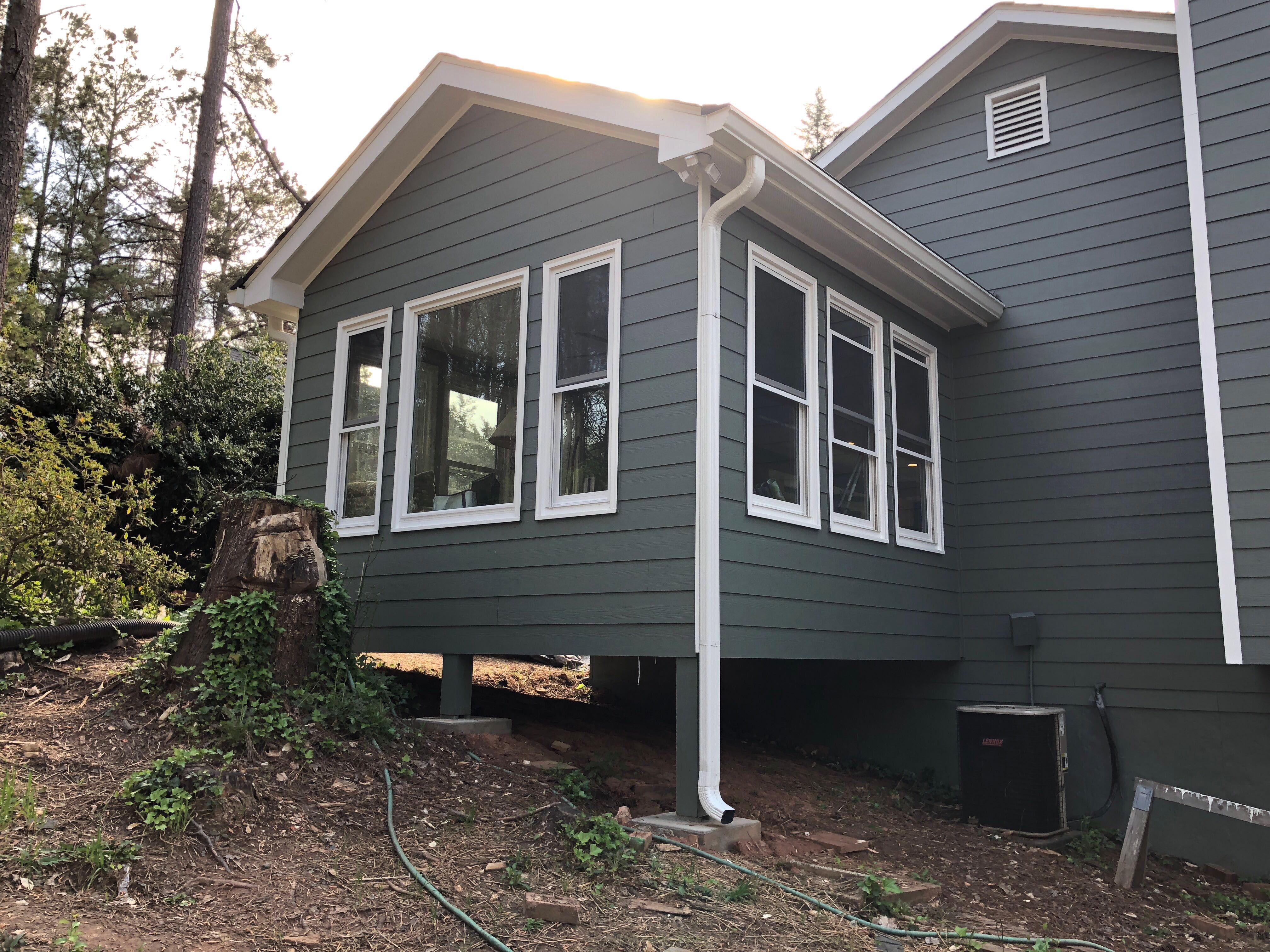 Elevated Sunroom Addition Featuring Dark Gray Siding in Kennesaw by Swift Home Renovations