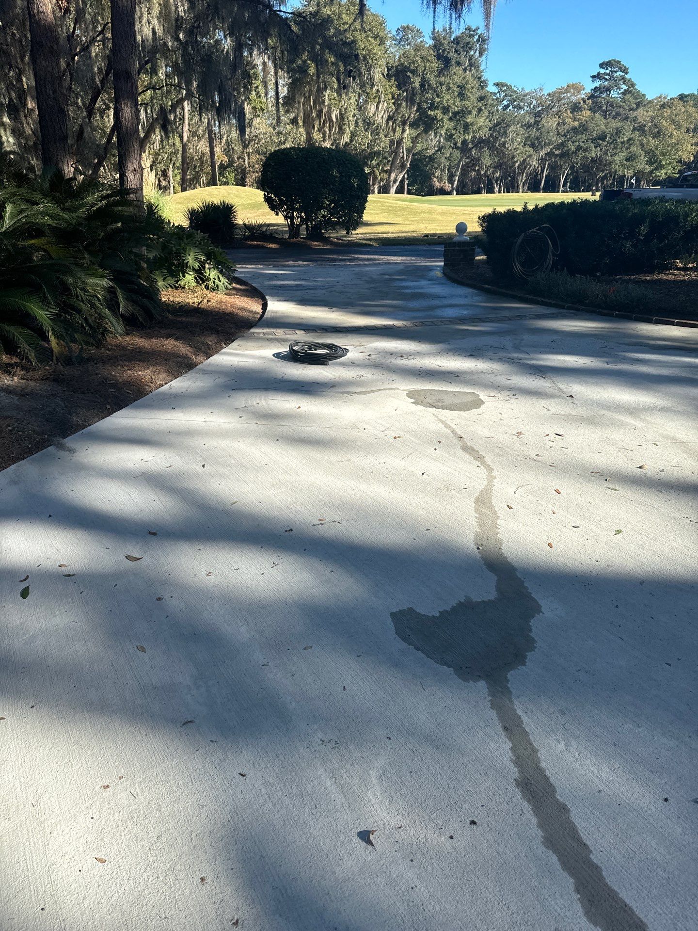 Custom Concrete Driveway Installation with Decorative Brick Borders in Okatie by Lowcountry Scapes, LLC