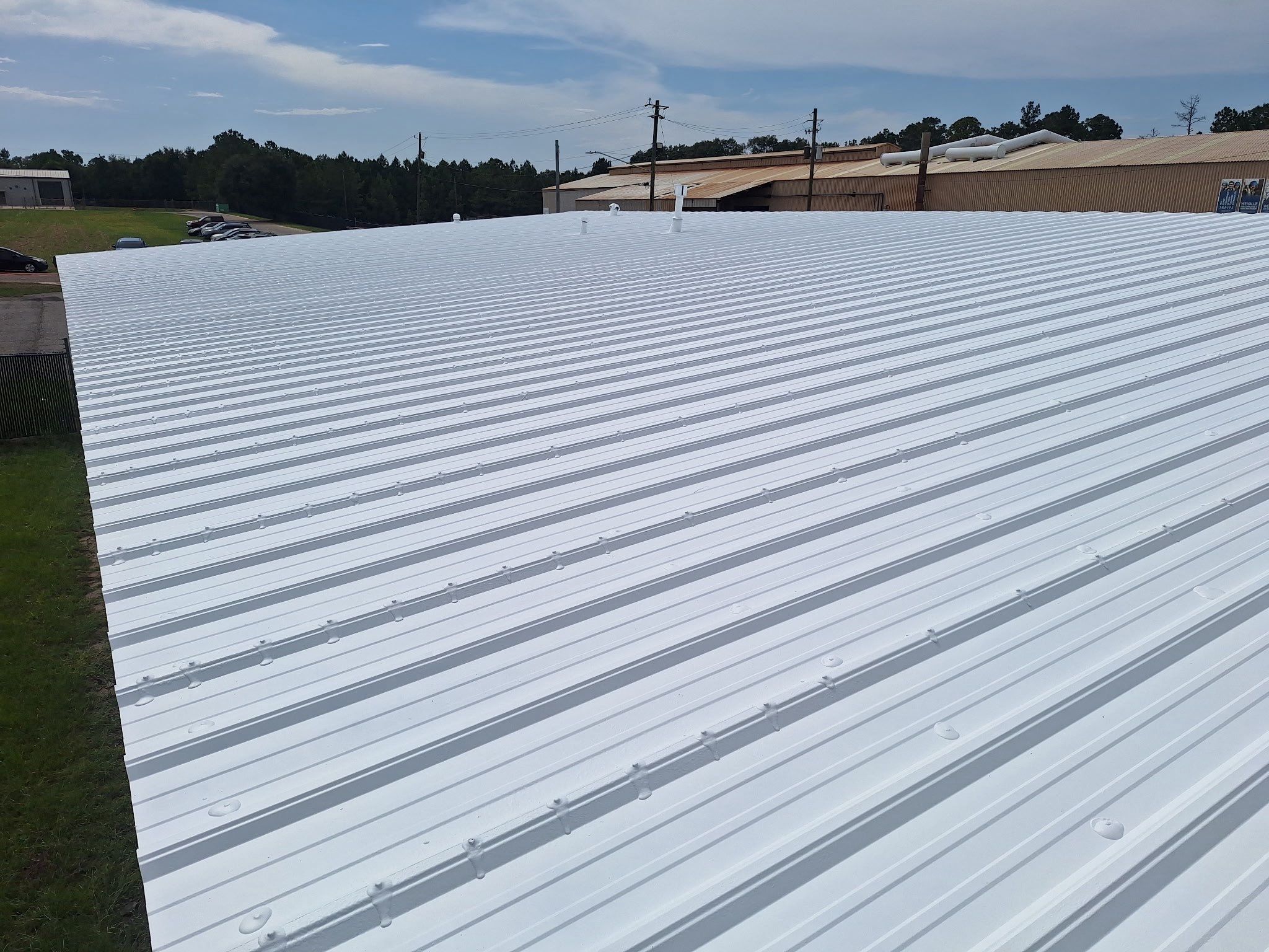 Commercial Metal Roof Restoration with White Protective Coating by Southern Roof Solutions