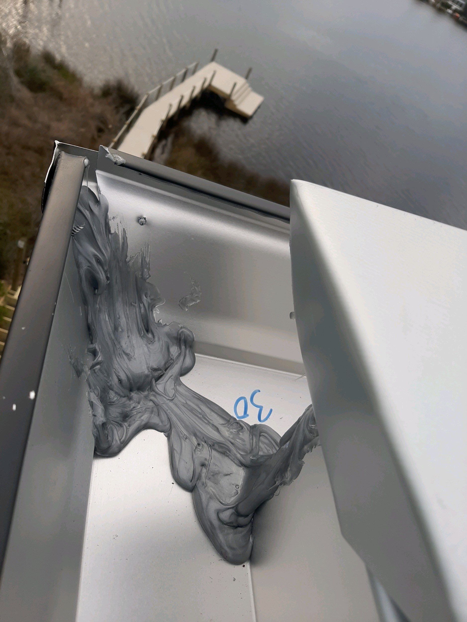 Seamless Gutter Installation Using Black Half Round Seamless Gutters by Gutter Professors