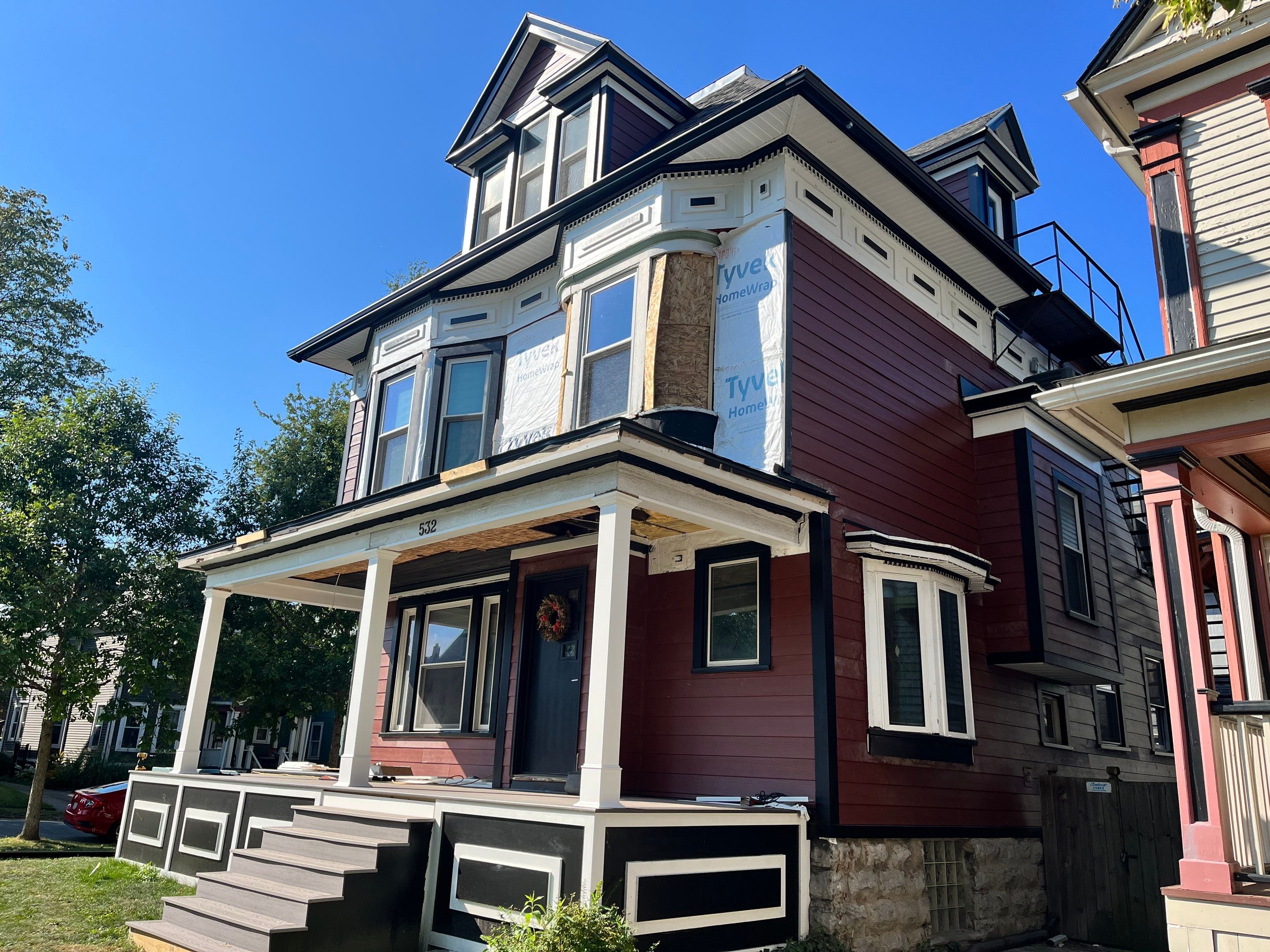 Exterior Renovations- Siding, Stamped Concrete, Porch, and Railings by Ivy Lea Construction