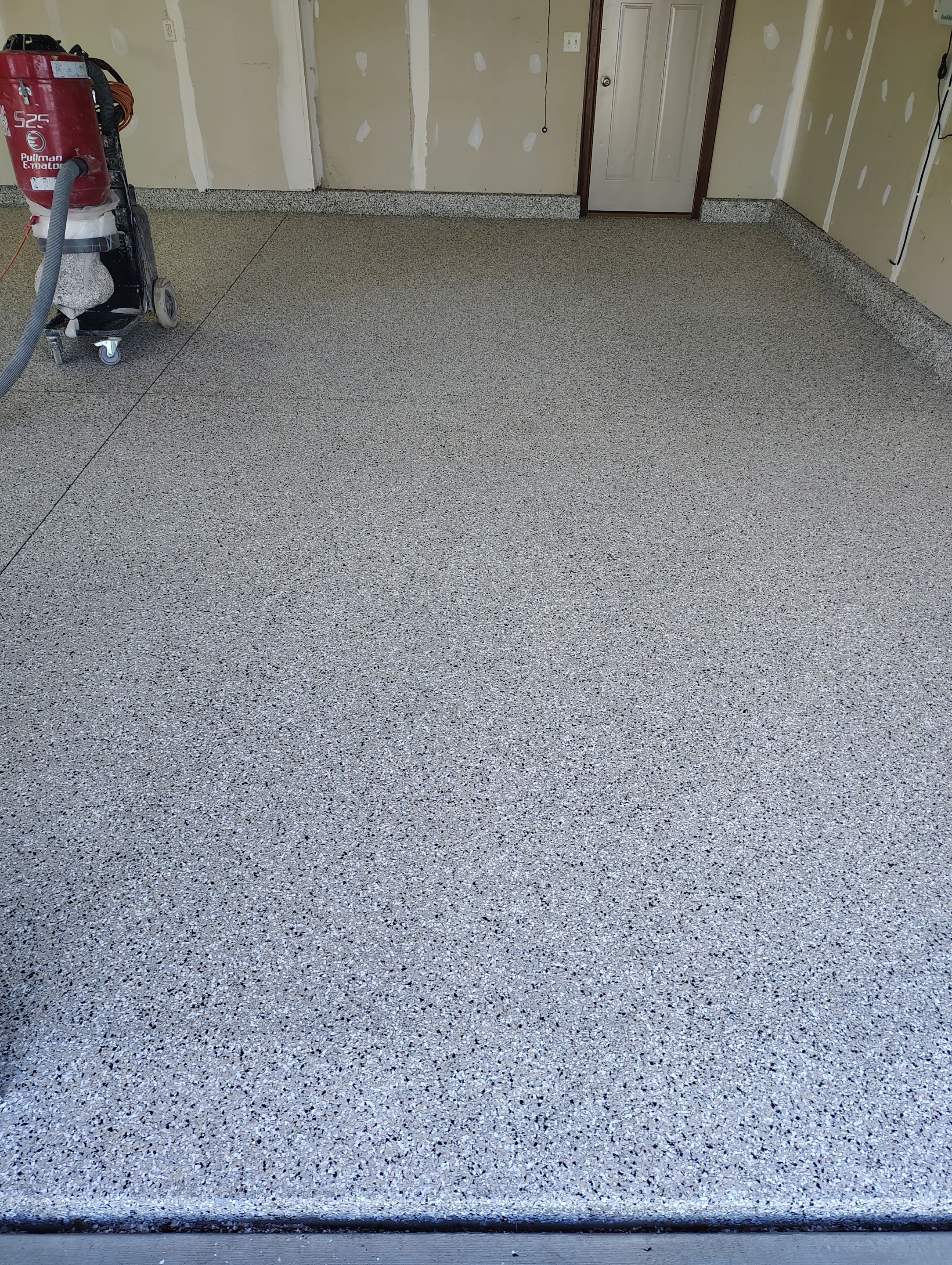 Multi-Car Garage Concrete Coating and Epoxy Finish in Sioux Falls by Select Painting, Coatings & Garage Cabinets