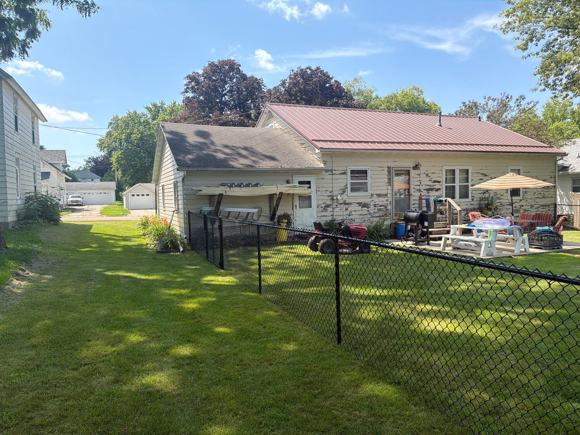 Black Chain Link Backyard Fence Installation in Tripoli, IA by Perfect Picket Fence and Stain