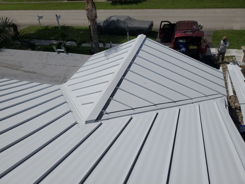 Residential Roofing Installation using 1.5" Nail Strip 24ga Solar White Kynar Coated Standing Seam Metal Panels by Morton Roofing, Inc.