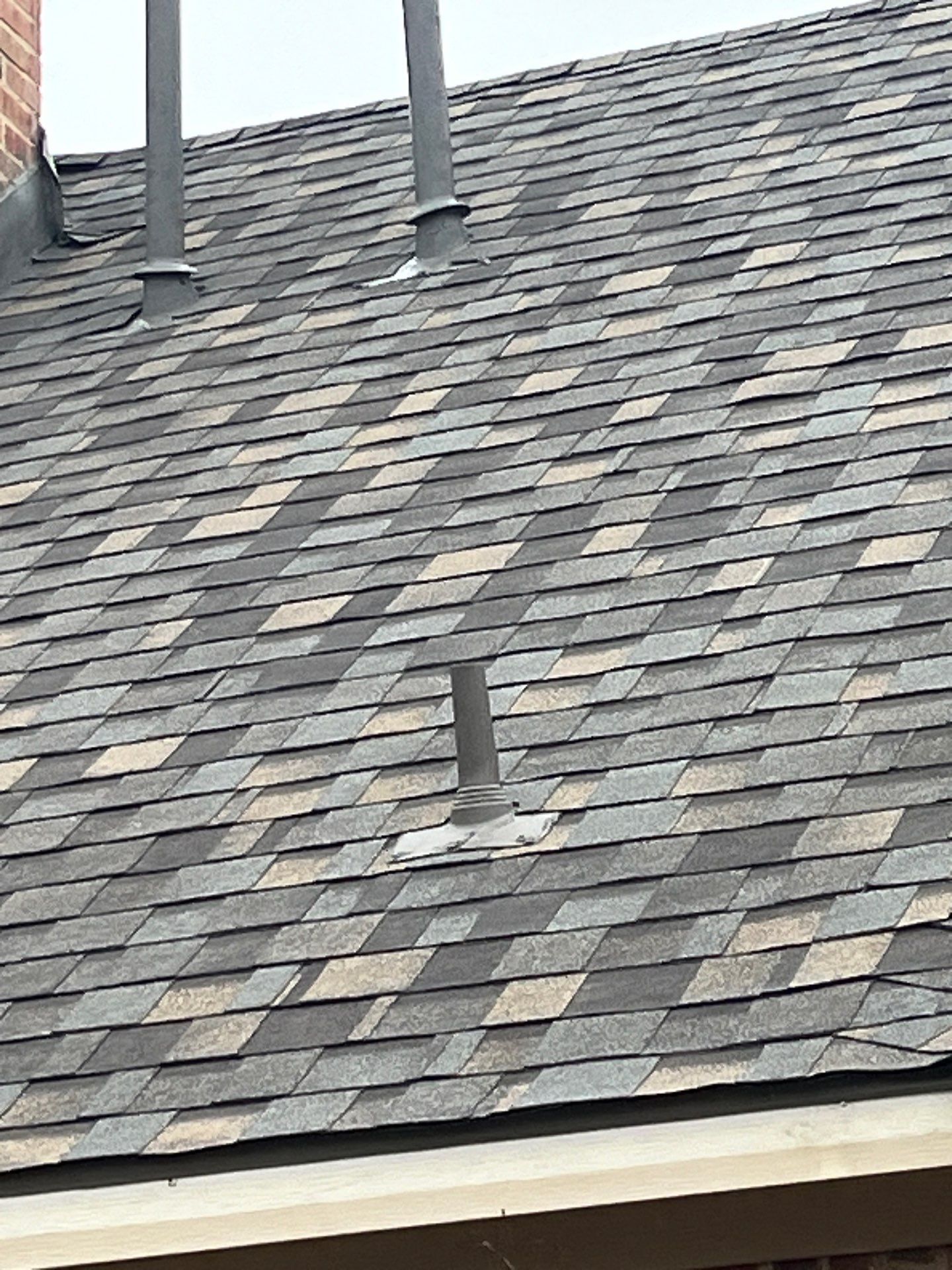 Light red brick/cream stone/espresso shutters with IKO Cornerstone by Tejas Roofworks + Restoration