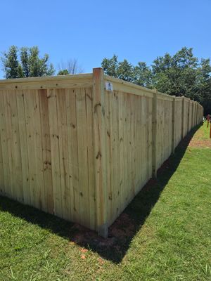 Fence Installation of a Capped Wood Privacy Fence