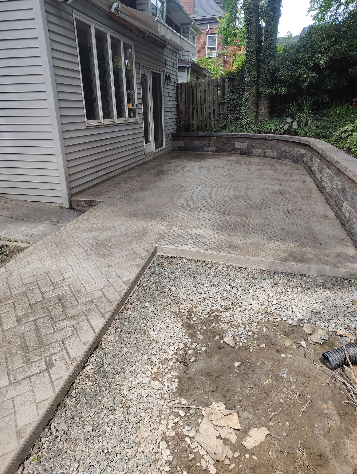 Stamped Concrete and Retaining Wall by Cousins Roofing Siding & Decks