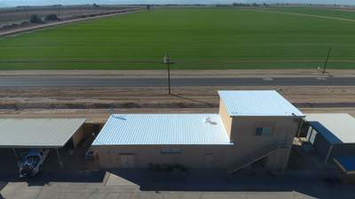 Metal roof restoration on commercial roof using Conklin Benchmark/PUMA XL fabric and coating