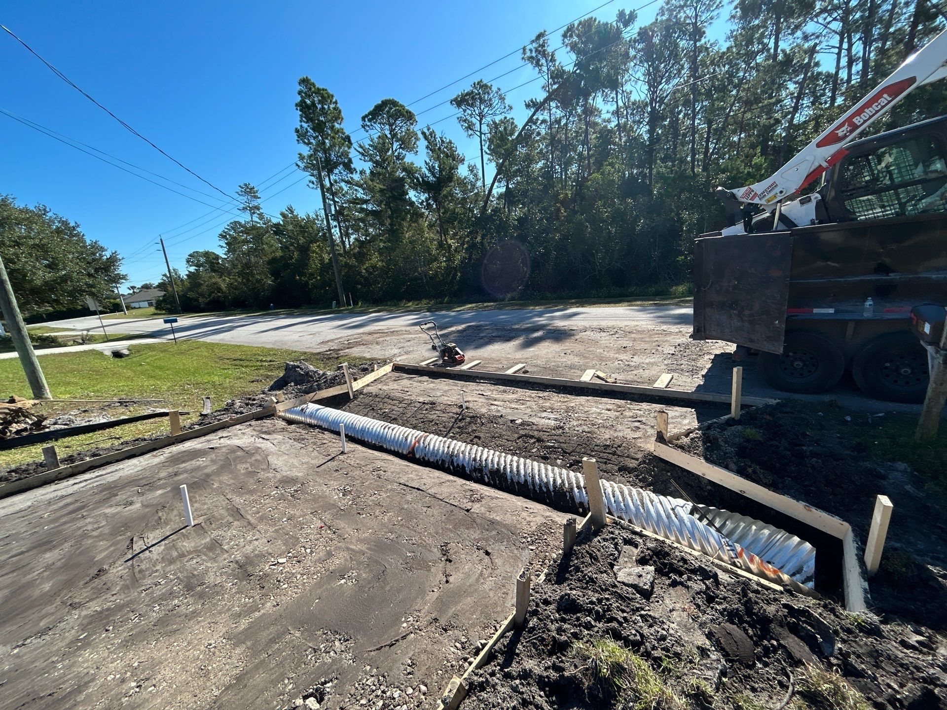 New concrete driveway by Courtesy screening