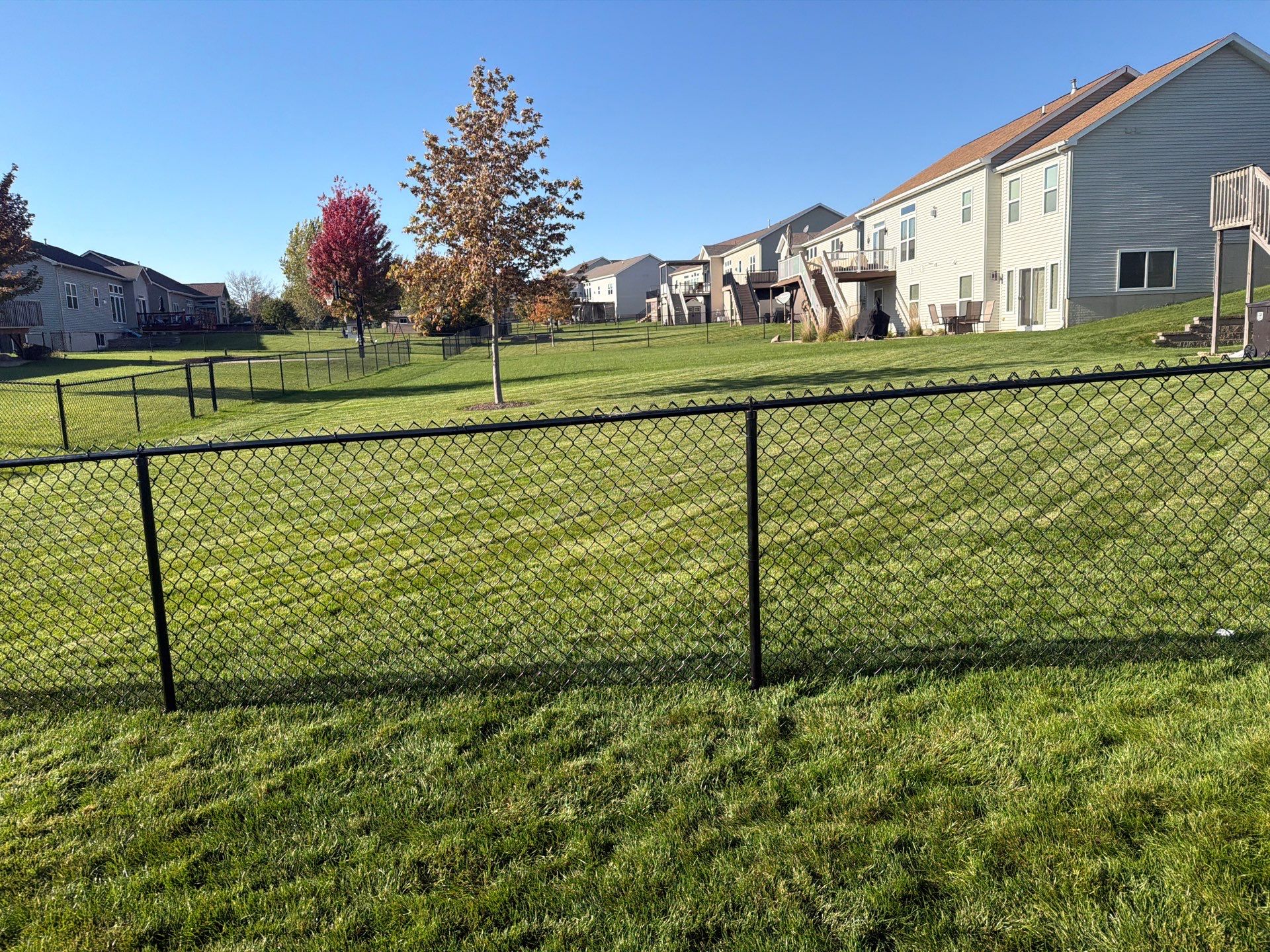 Black Vinyl-Coated Chain Link Fence Installation in Cedar Falls by Perfect Picket Fence and Stain