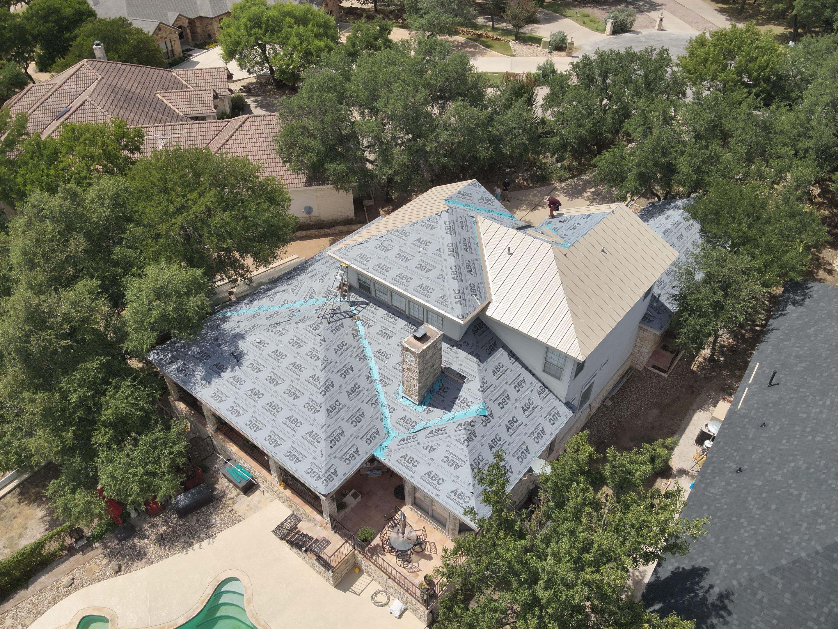 Residential Roof Replacement using 24 GA Double-Lock - Surrey Beige by Action Exteriors Austin
