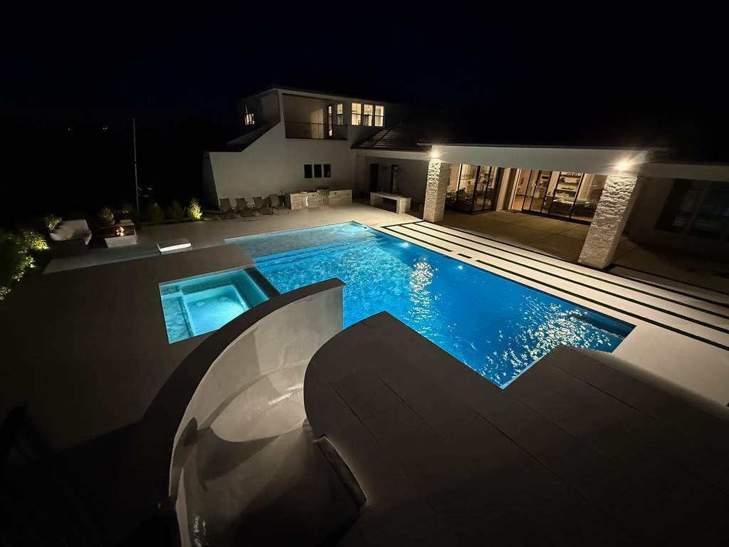 Pool and spa build with slide & outdoor kitchen by Modern Pools