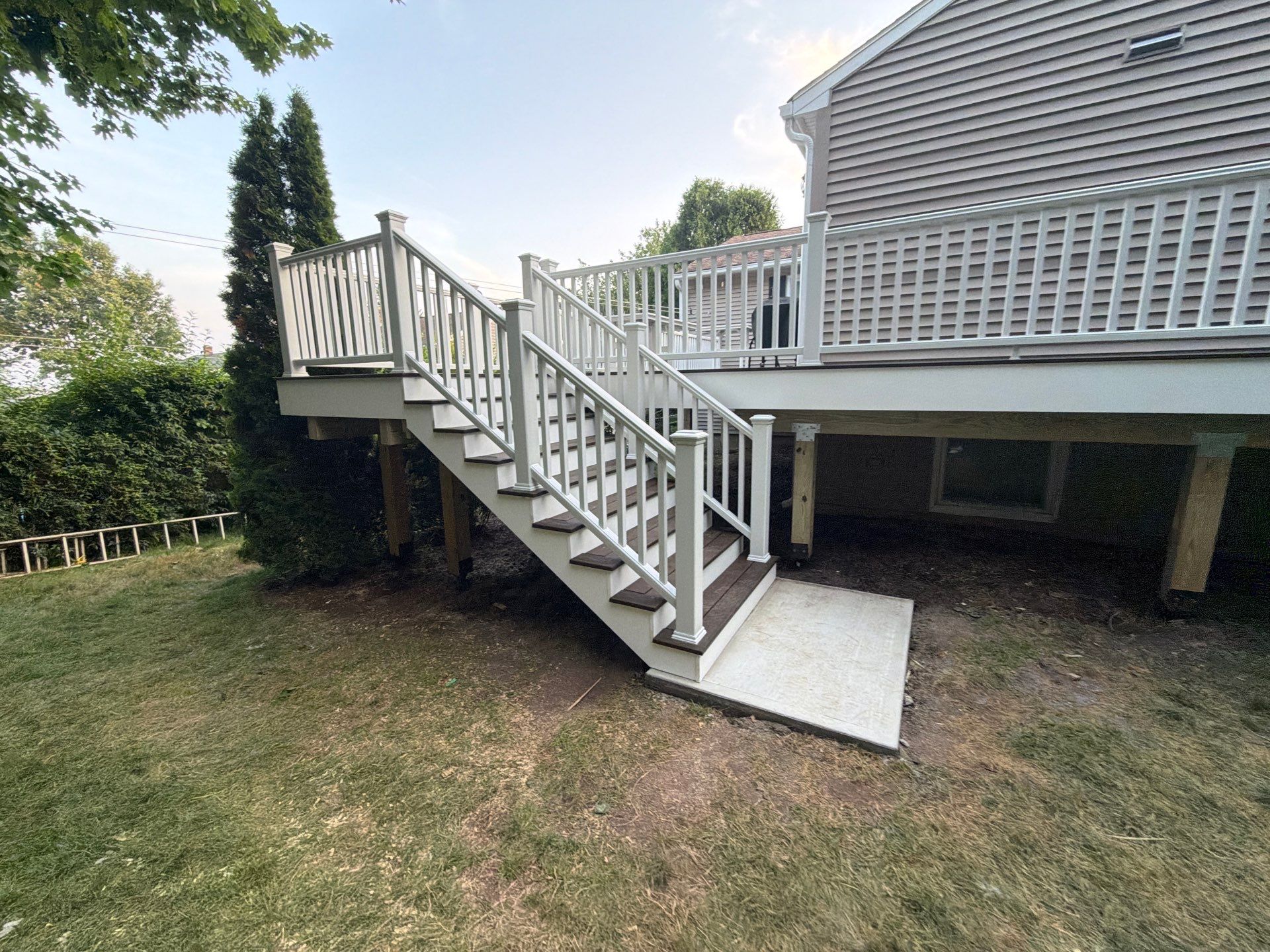 Deck Replacement using Trex Tropical Spiced Rum decking and Transcend White Railing by DiGiorgi Roofing and Siding Inc