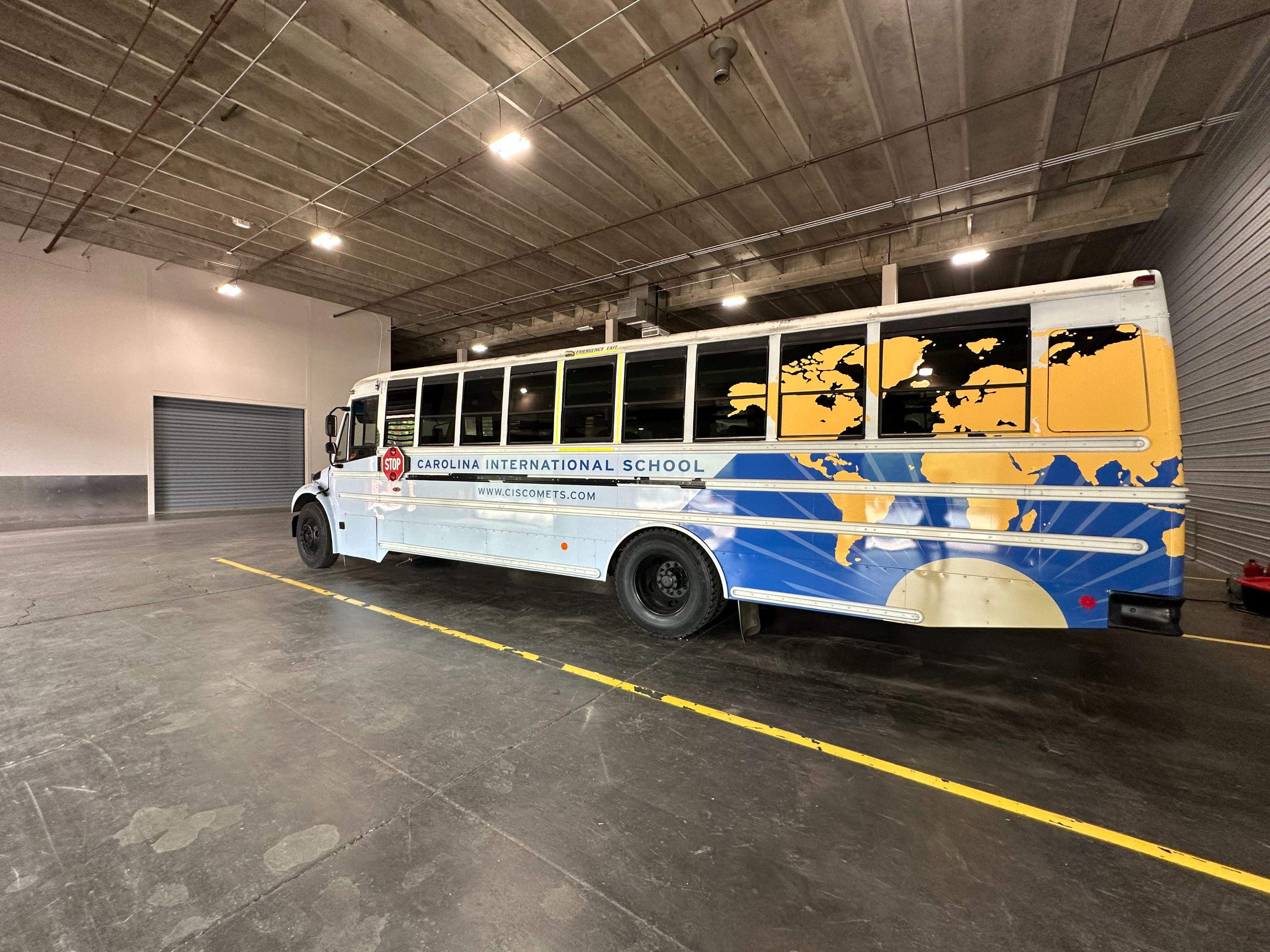 Carolina International School - Bus Vinyl Wrap by QC Signs and Graphics