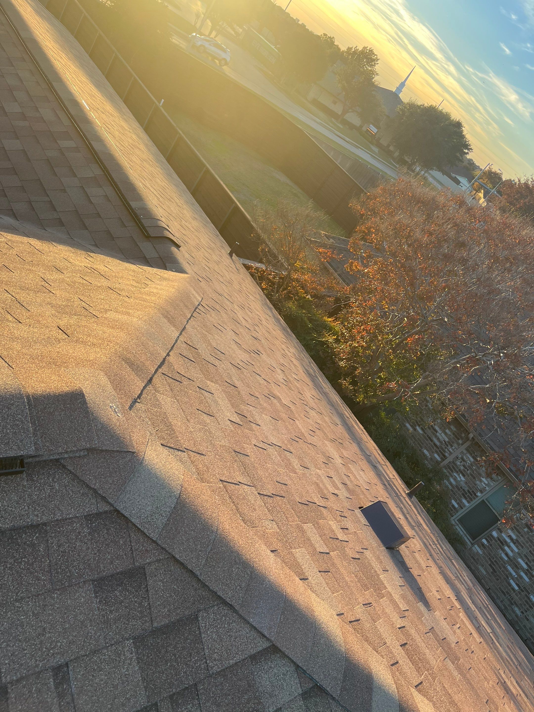 Brick with white area around windows with Malarkey Sienna Blend by Tejas Roofworks + Restoration