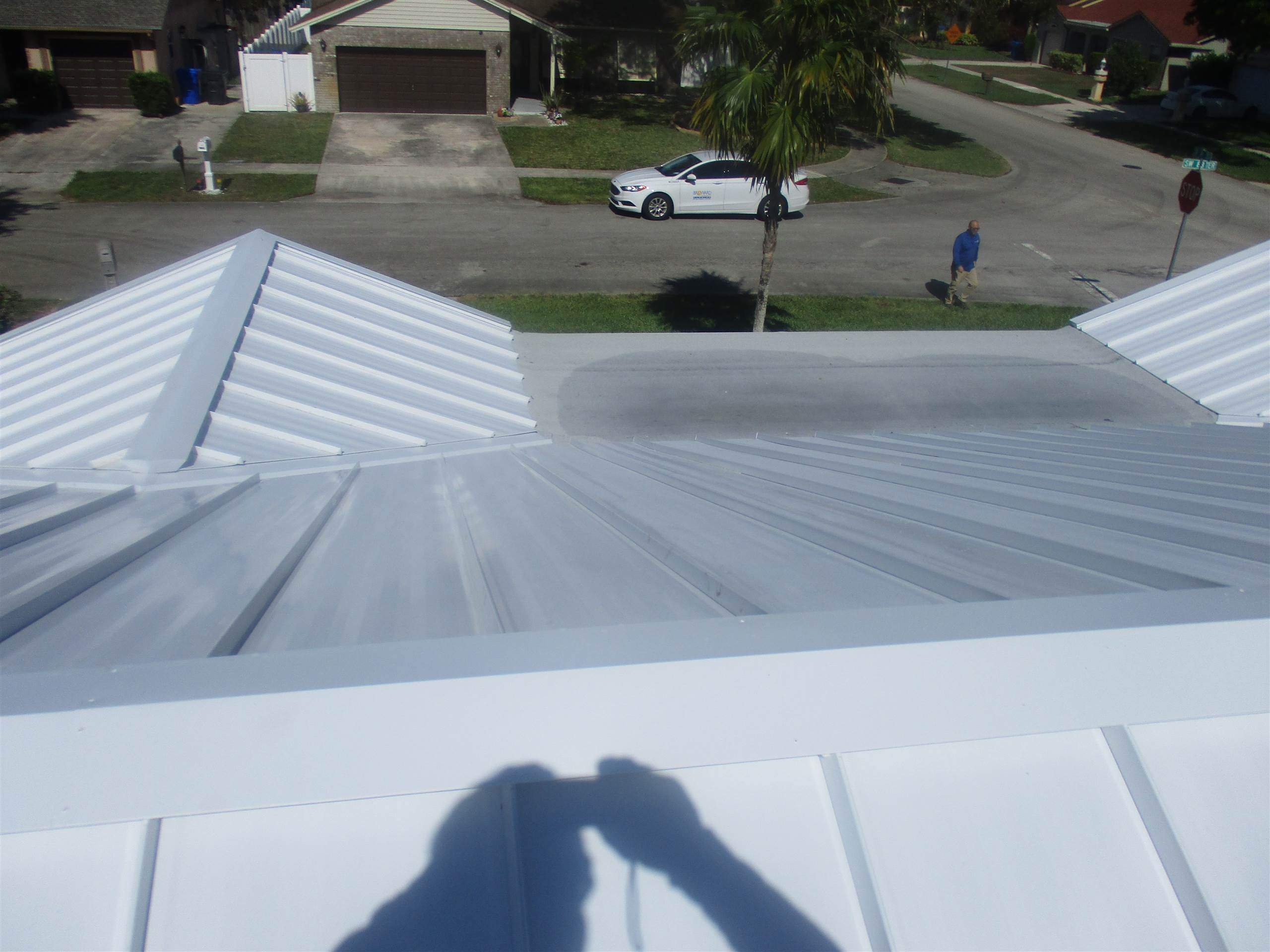 Standing Seam Metal & Flat Re-Roof using 1.5" Nail Strip 24ga Solar White Kynar Coated Standing Seam Metal Panels by Morton Roofing, Inc.