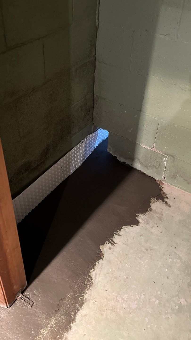 Interior drain tile system installation by ACE Waterproofing & Basement Solutions