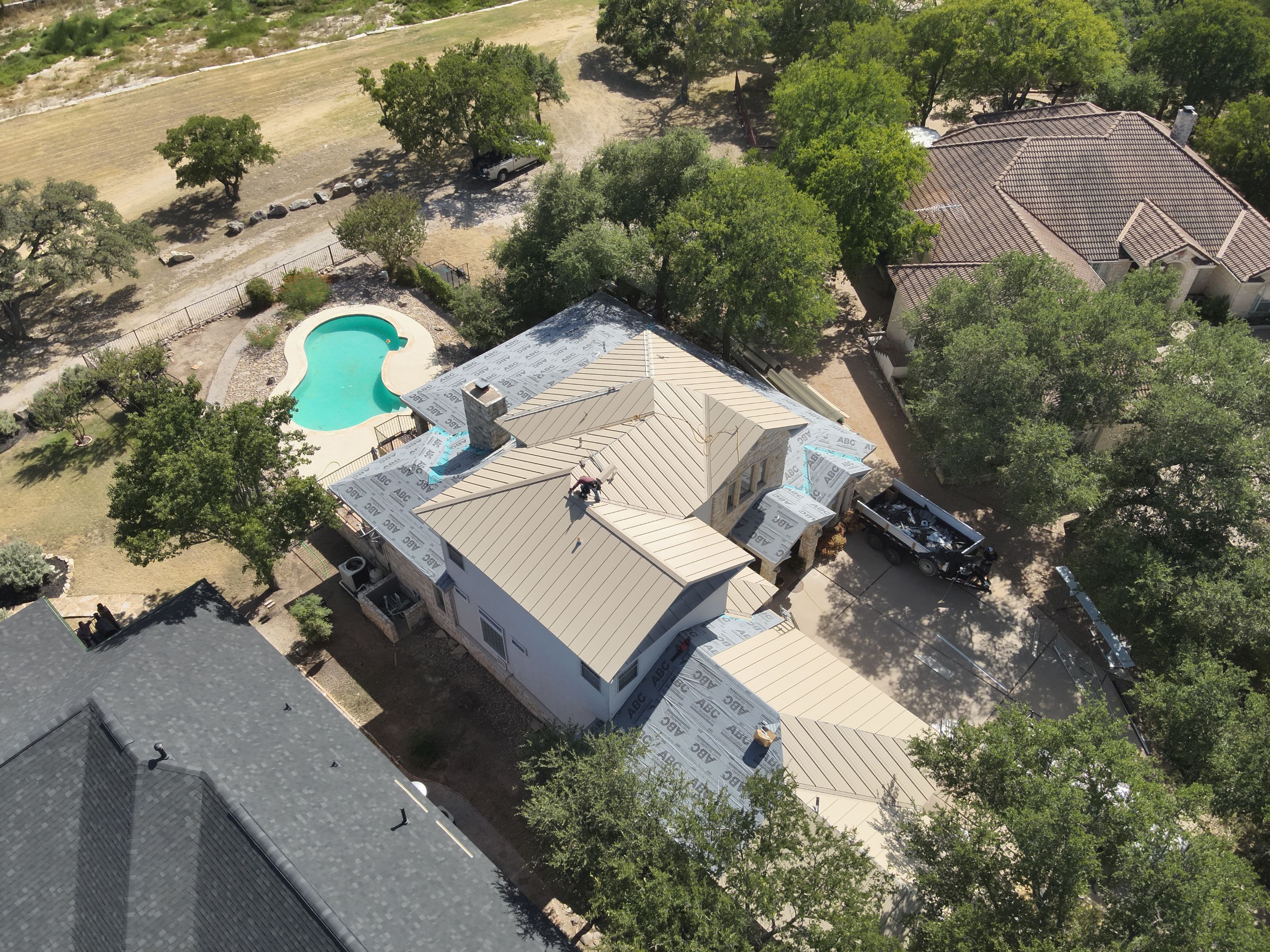 Residential Roof Replacement using 24 GA Double-Lock - Surrey Beige by Action Exteriors Austin