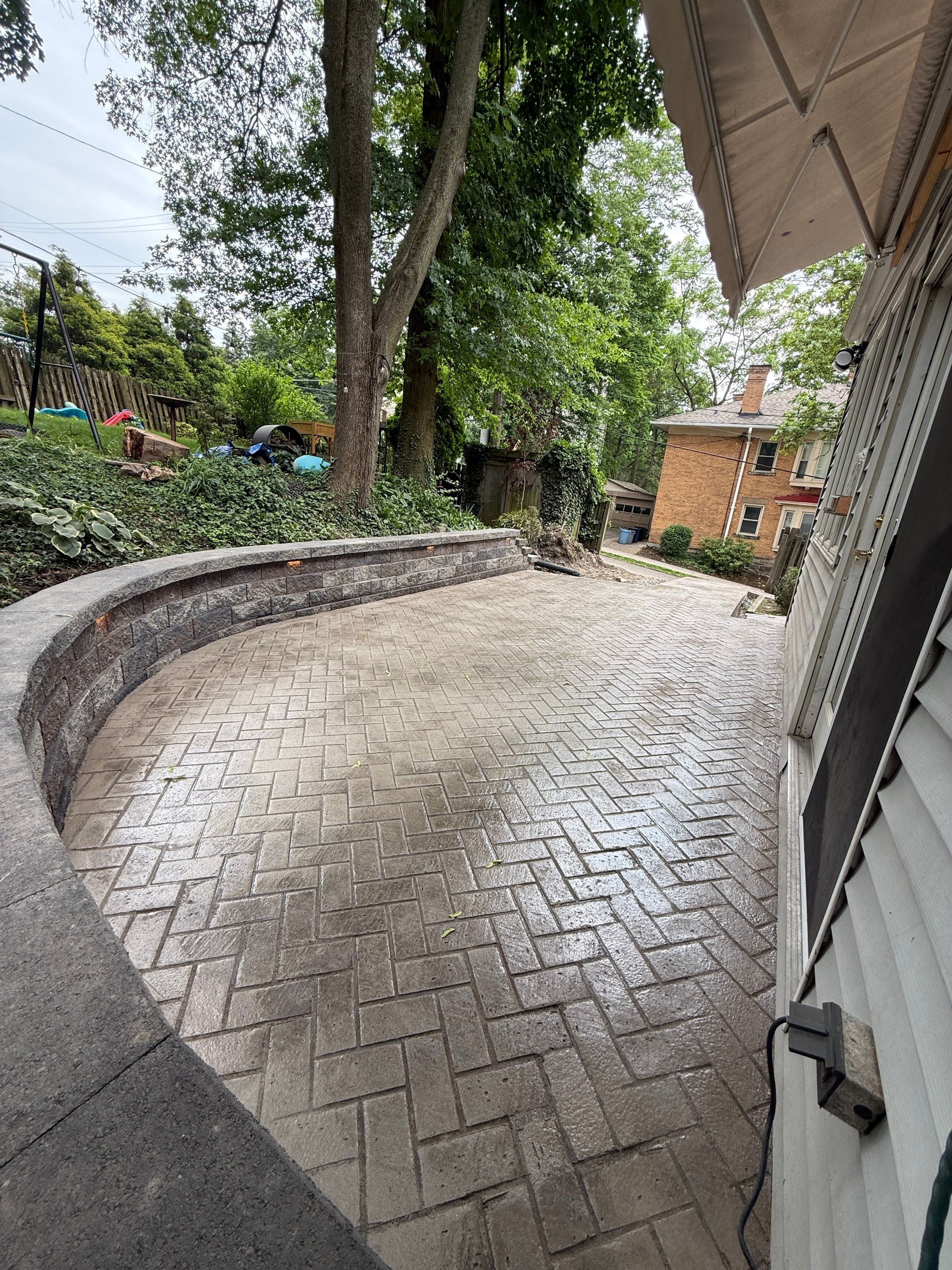 Stamped Concrete and Retaining Wall by Cousins Roofing Siding & Decks
