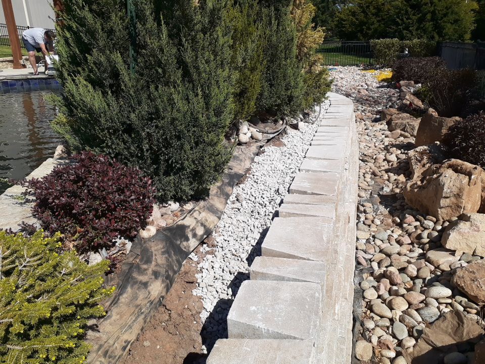 Pool Retaining Wall by LAND ESCAPES LLC
