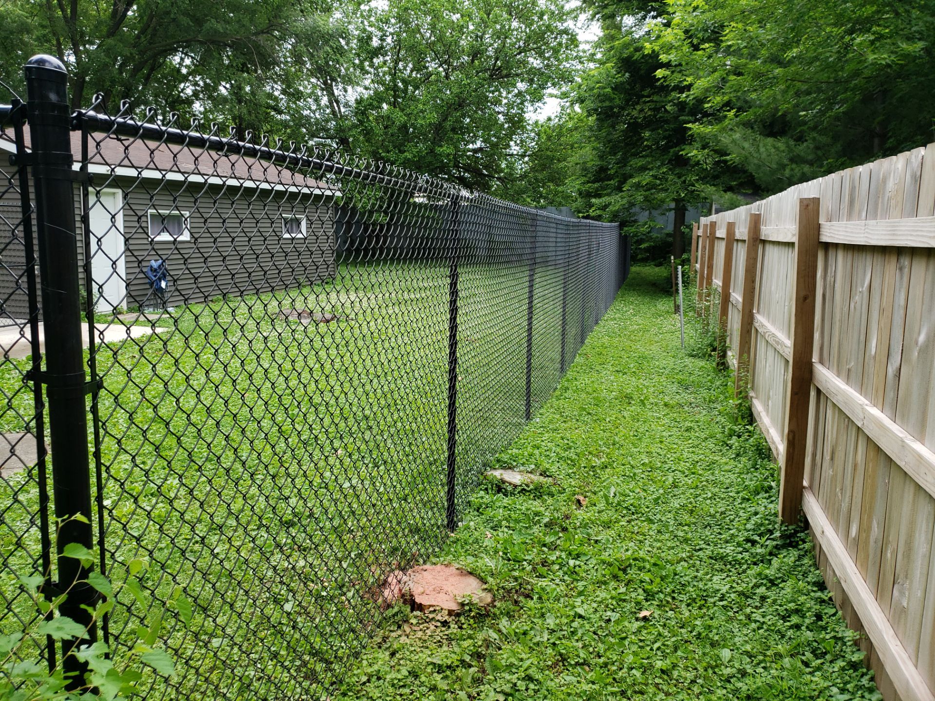 Black Vinyl Chain Link Fence Installation in Charles City by Perfect Picket Fence and Stain