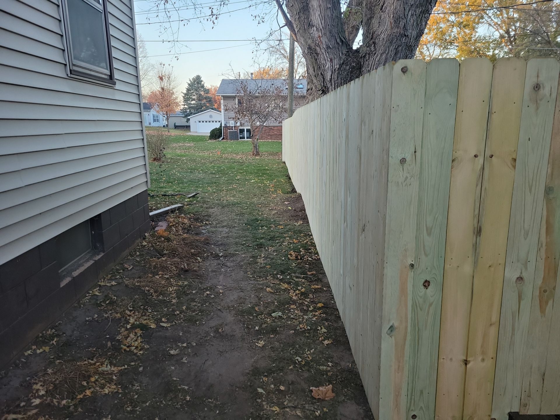 New Pressure-Treated Wood Privacy Fence and Gate in Charles City by Perfect Picket Fence and Stain
