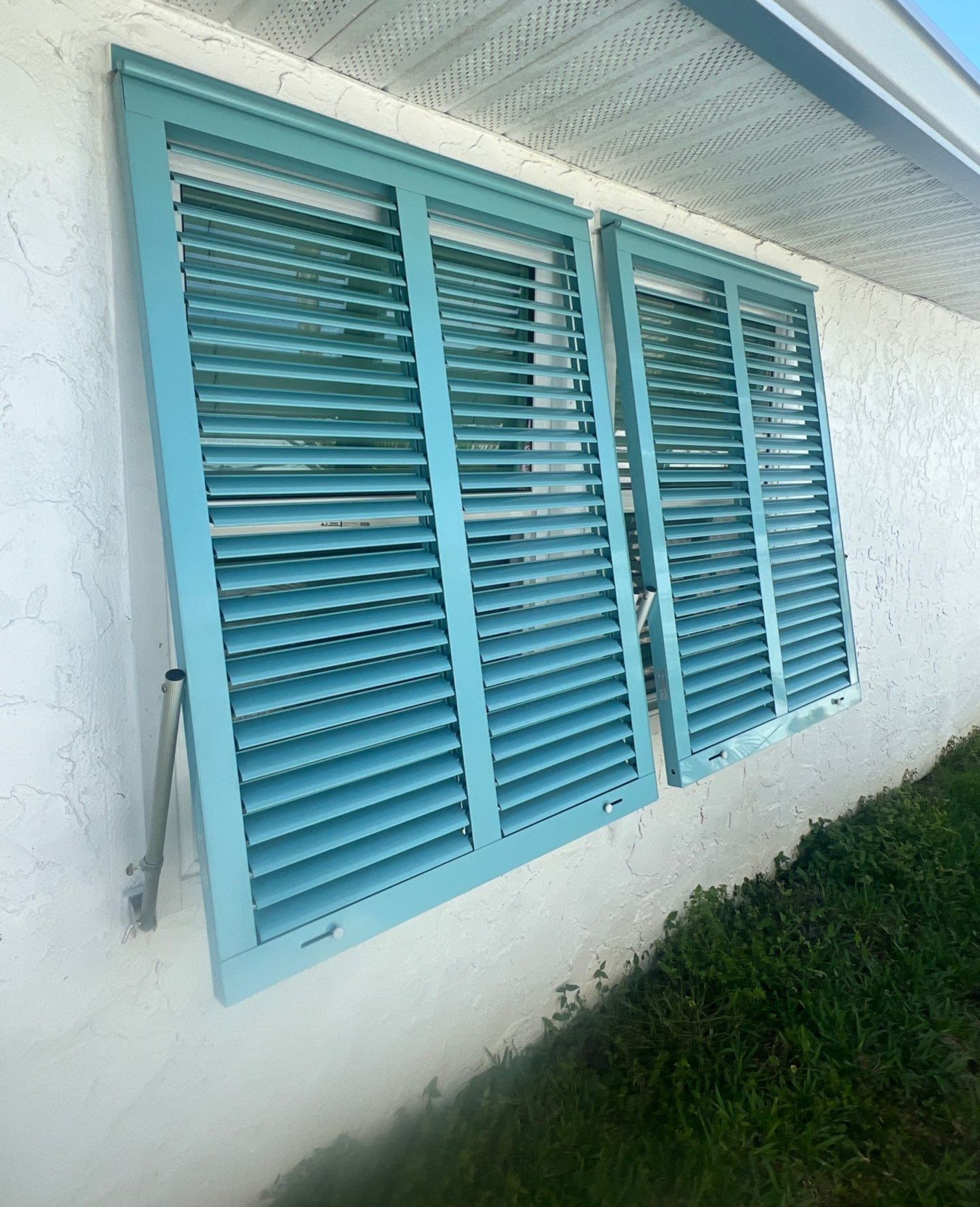 Hurricane Rated Bahama Shutters in Pastel Turquoise  by Smart Guard Shutters