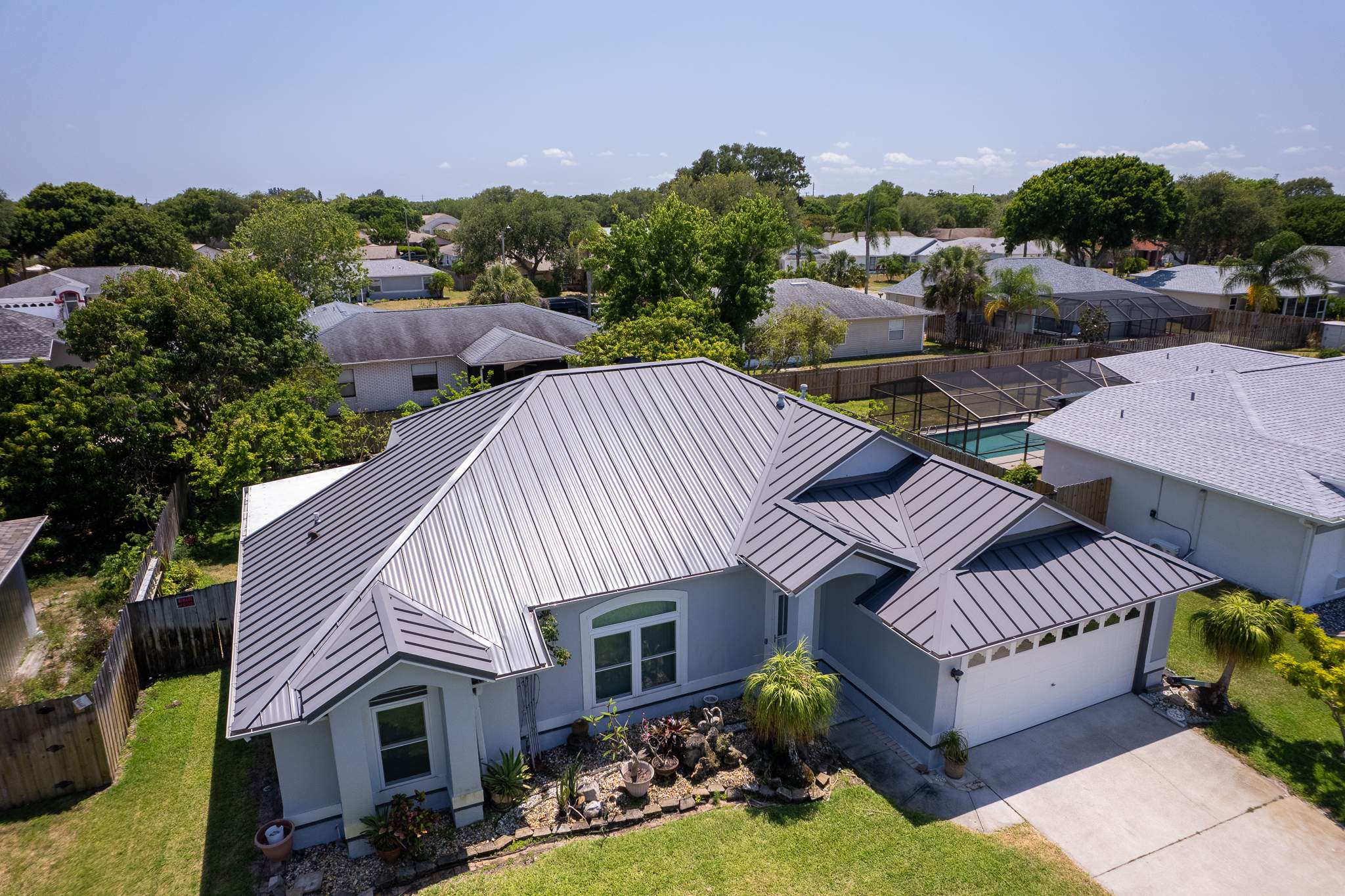 Complete Metal Roof Replacement and Seamless Gutter Installation in Melbourne by Wiedmann Construction & Roofing