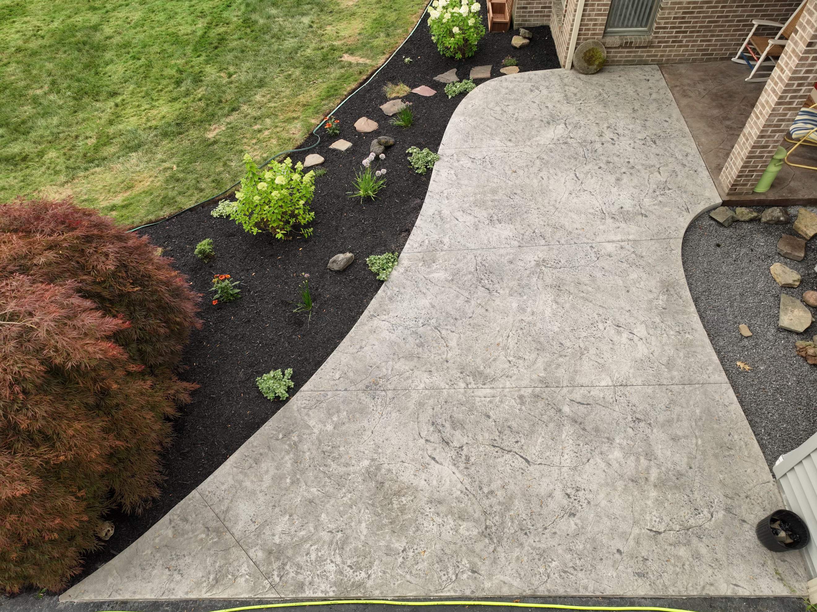 Heavy stone textured stamped concrete patio  by NG Masonry & Construction LLC