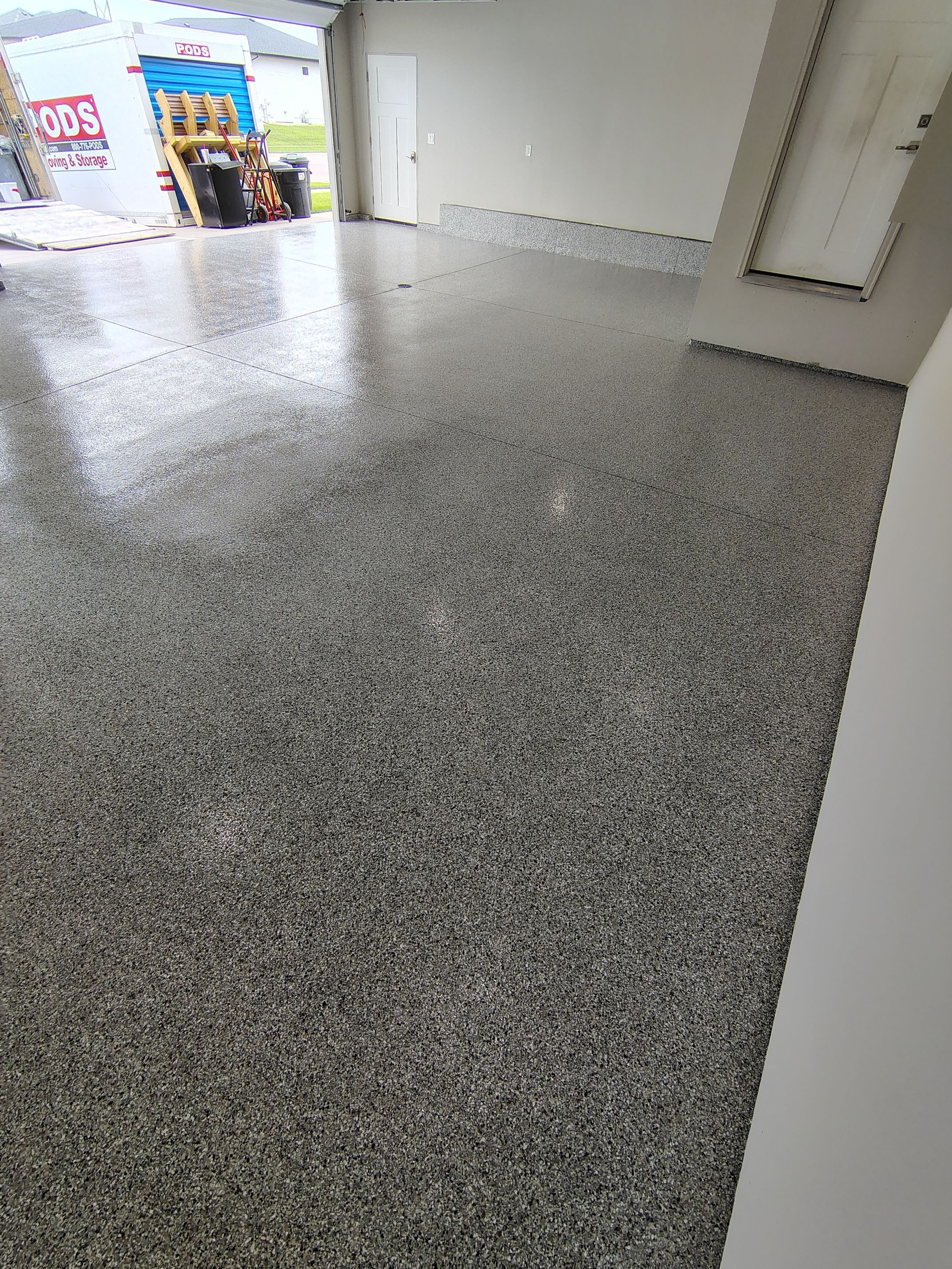 Grey Speckled Epoxy Garage Floor Coating in Sioux Falls by Select Painting, Coatings & Garage Cabinets