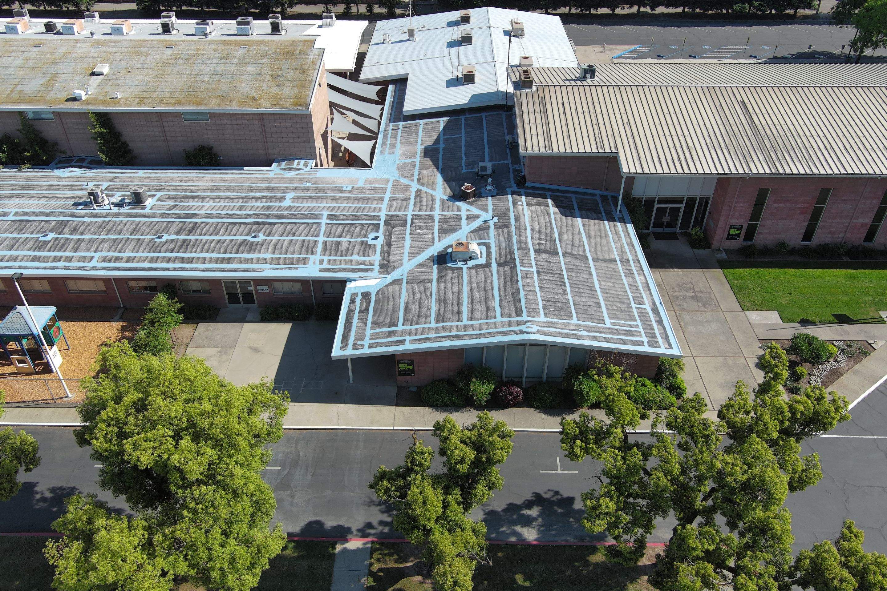 Single-ply restoration system using Benchmark/PUMA XL coatings over TPO single-ply roofing by Straight Edge Roofing Inc