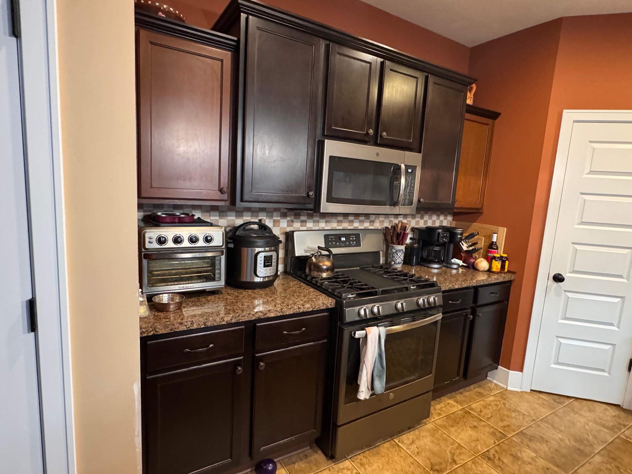 Sage Green Kitchen Cabinet Refinishing and Renovation in Webberville by Top Shelf Painter