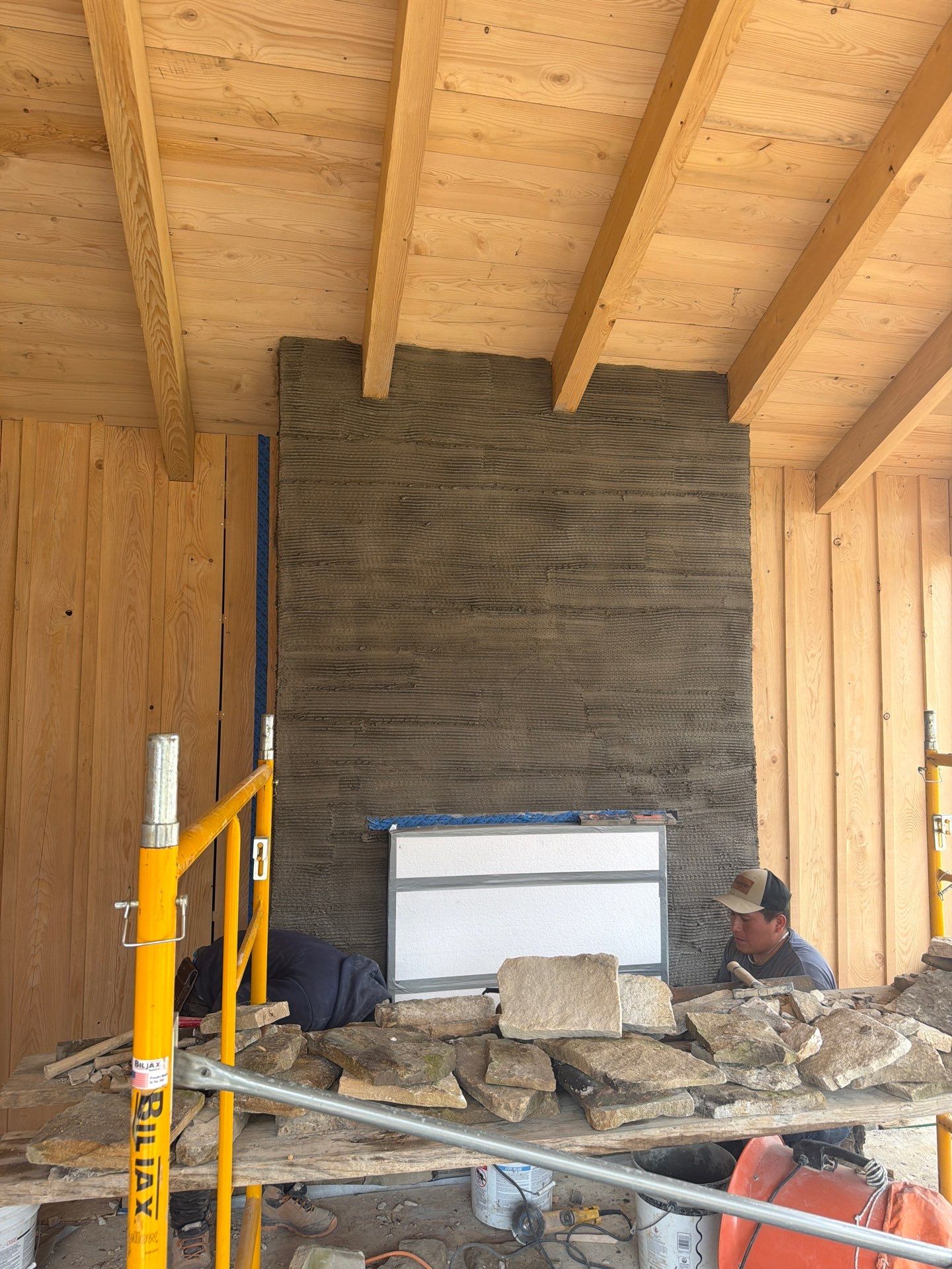 Custom Composite Deck with Stone Fireplace and Modern Cable Railing by Walnut Hollow Decks & Outdoor Living