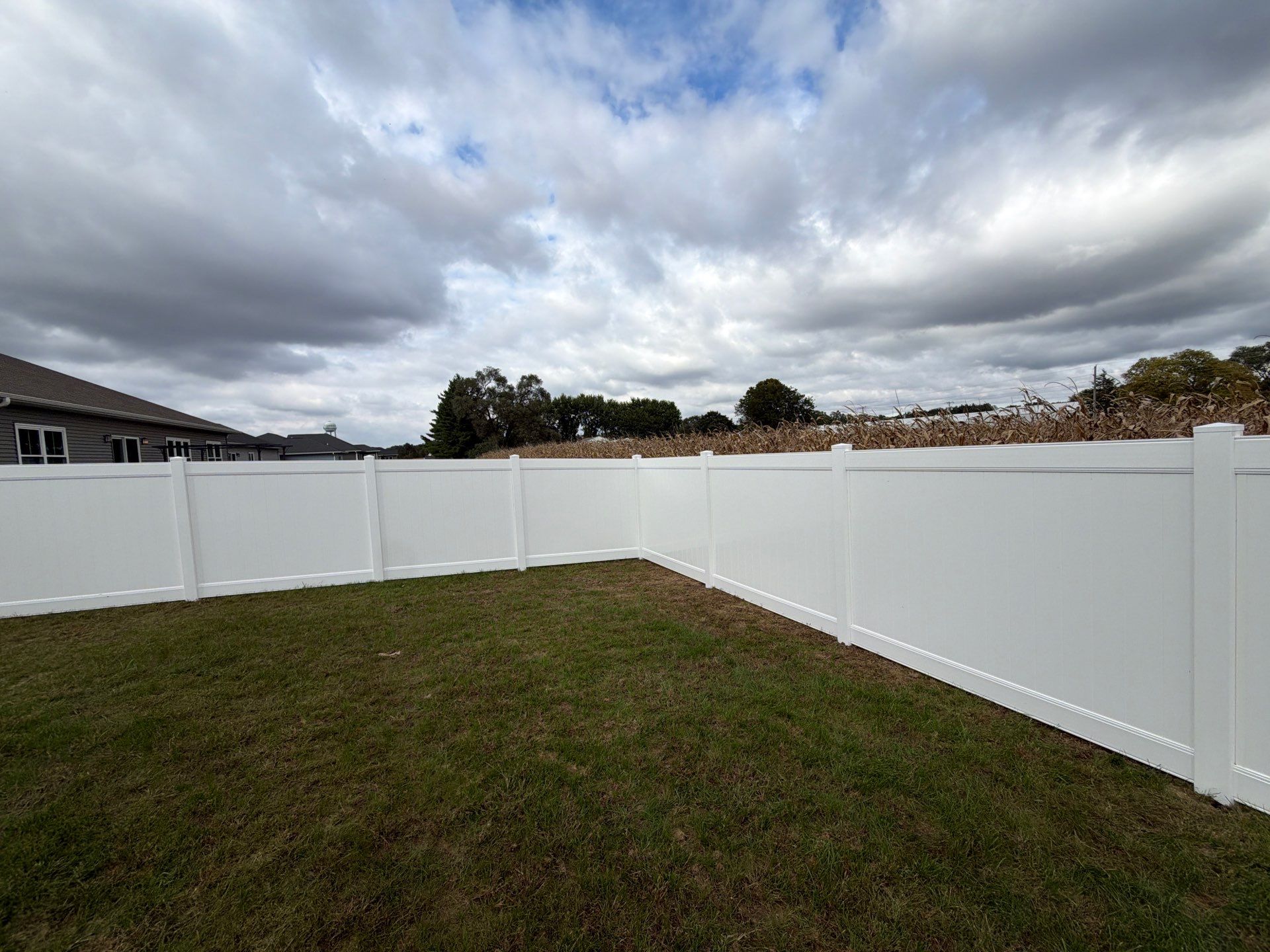 Residential White Vinyl Privacy Fence Installation in Janesville by Perfect Picket Fence and Stain