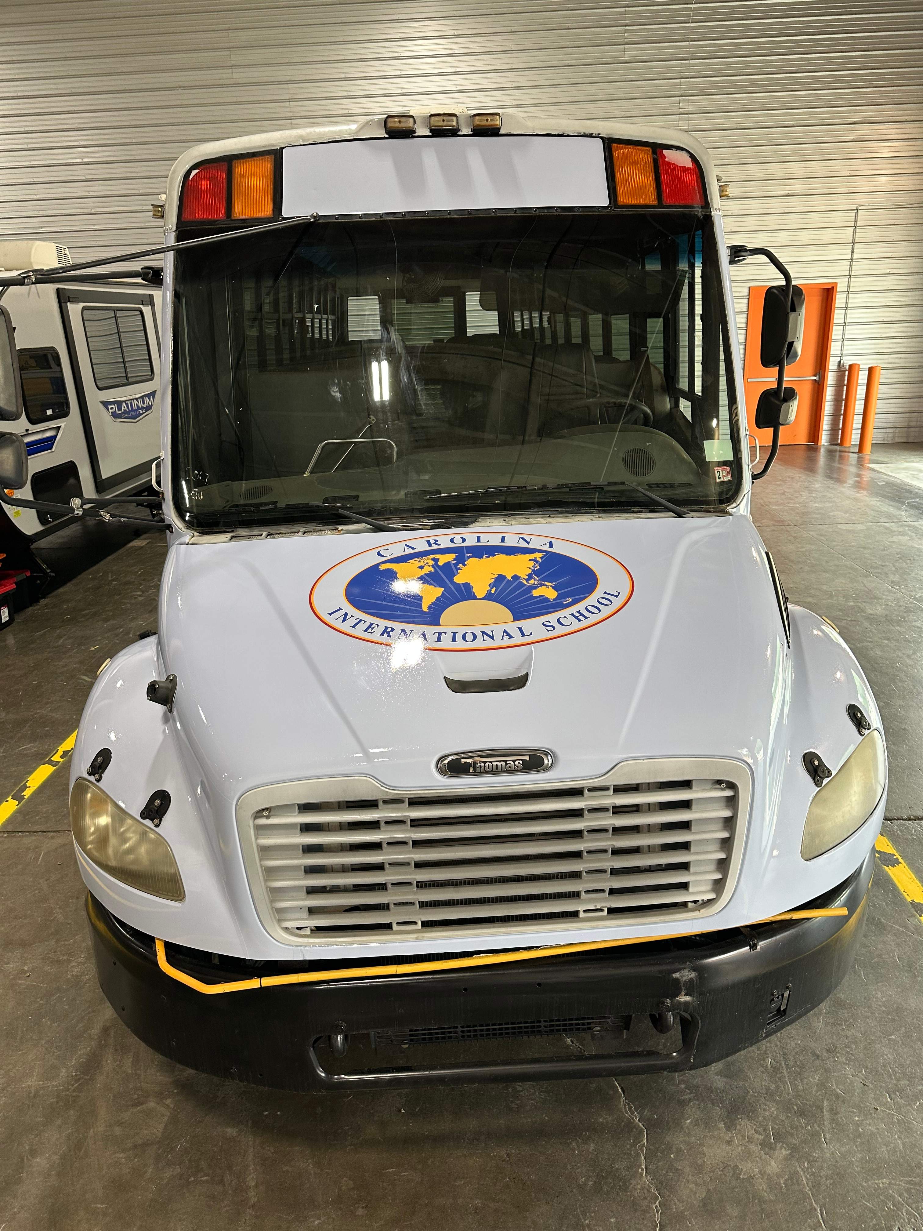 Carolina International School - Bus Vinyl Wrap by QC Signs and Graphics