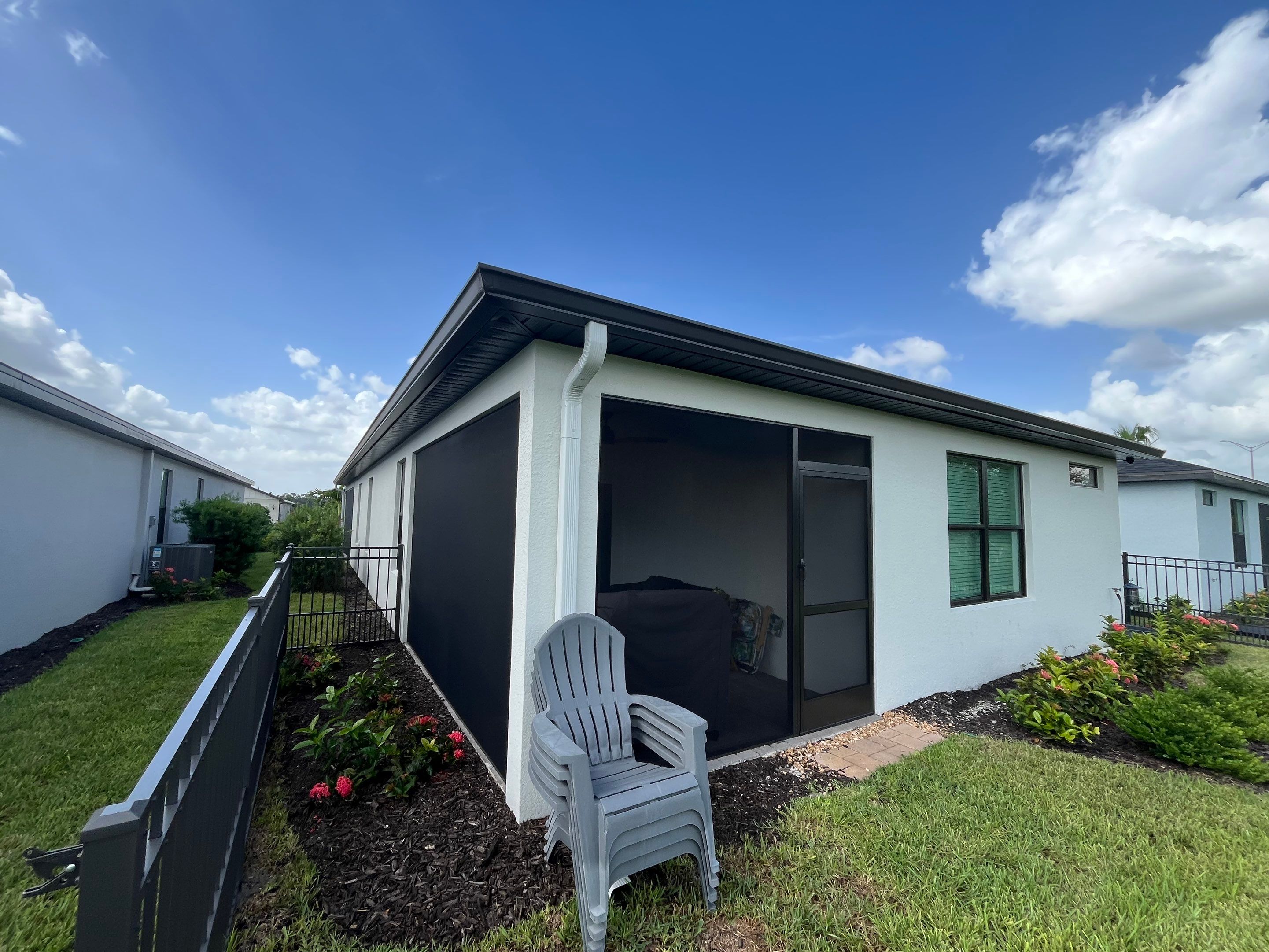 Dark Bronze Gutters and White Downspouts in Sarasota FL by Gutter Professors