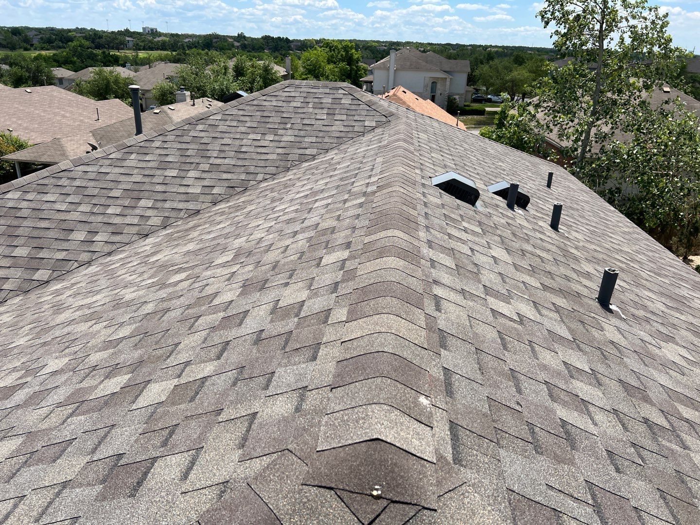 Wind damaged roof replacement by Oakwood Roofing and Construction, LLC