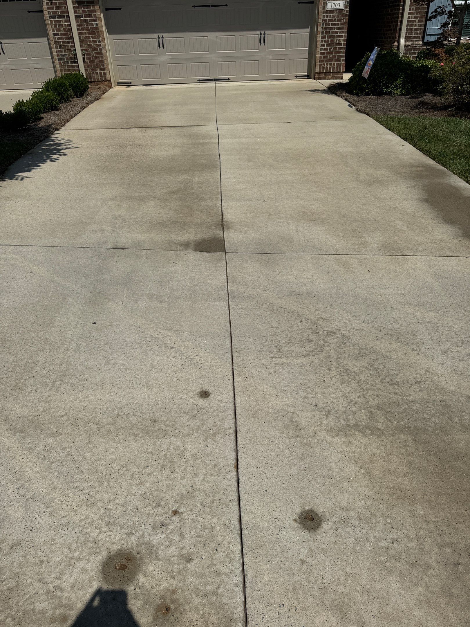 the service being performed is cleaning a concrete driveway to remove stains and dirt for improved appearance and maintenance