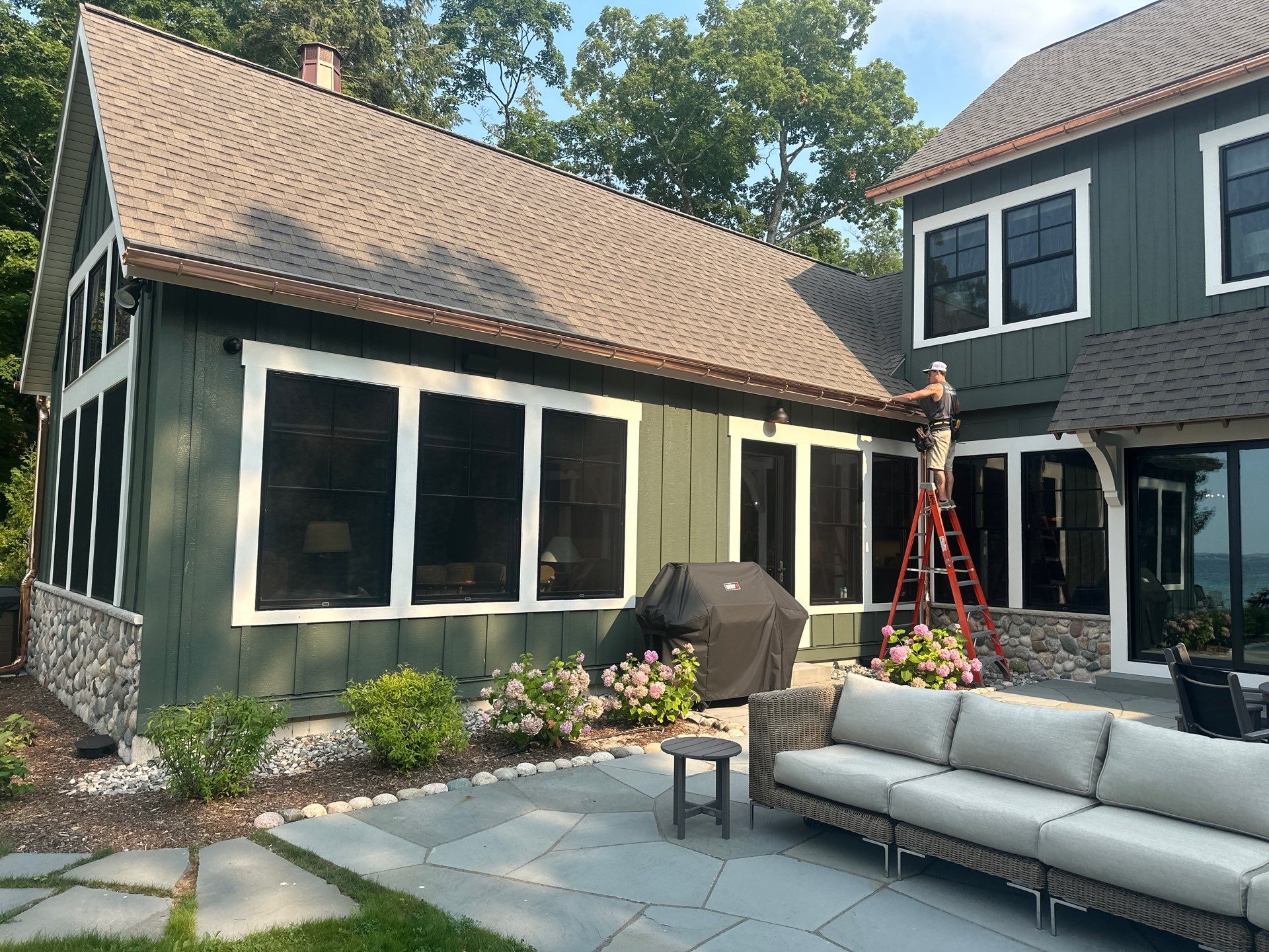 Copper Gutter and Downspout Installation for Omena Residence by Rainbow Seamless Systems