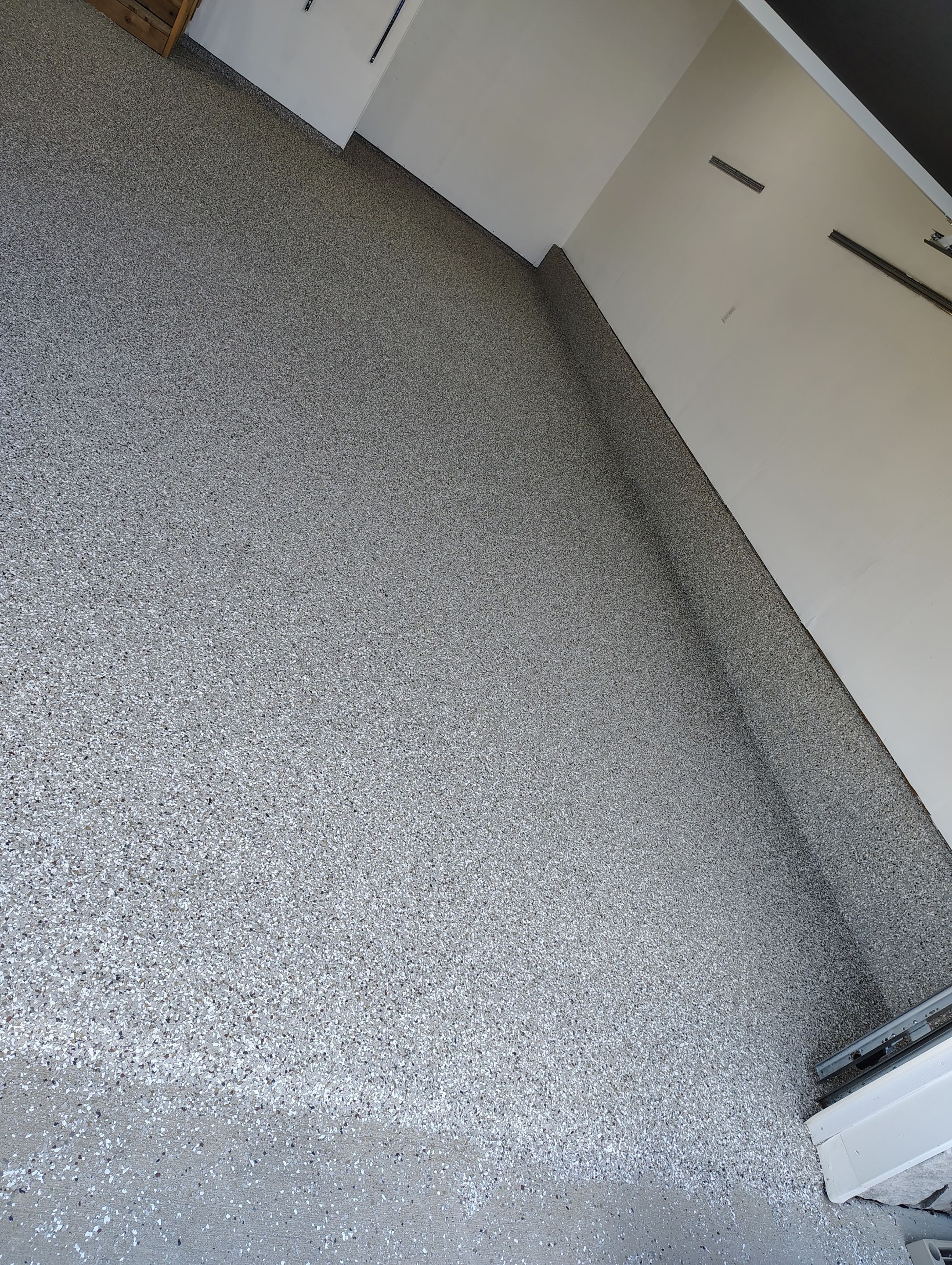 Sioux Falls Garage Floor Transformation With Gray Speckled Epoxy Coating by Select Painting, Coatings & Garage Cabinets