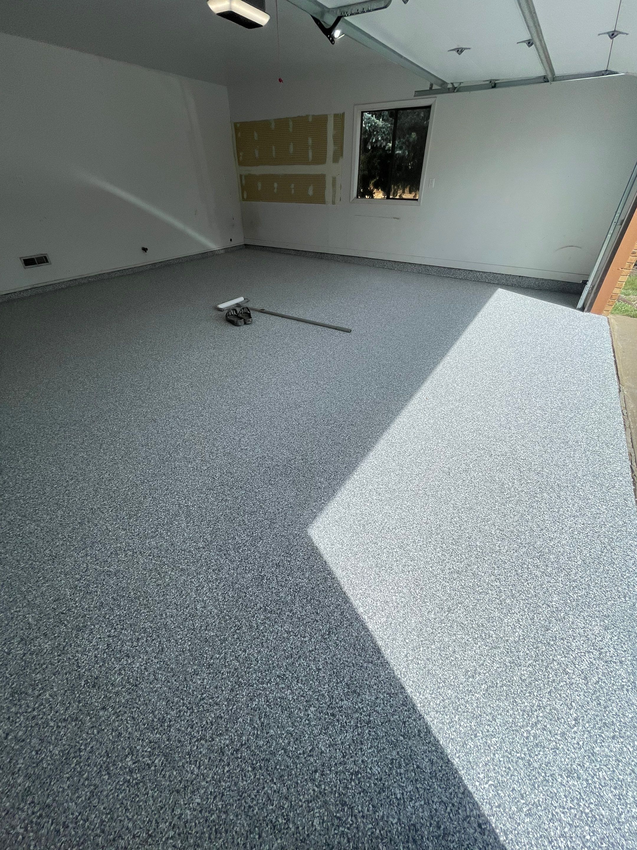 Grey Speckled Concrete Coating for Residential Garage in Yankton by Select Painting, Coatings & Garage Cabinets