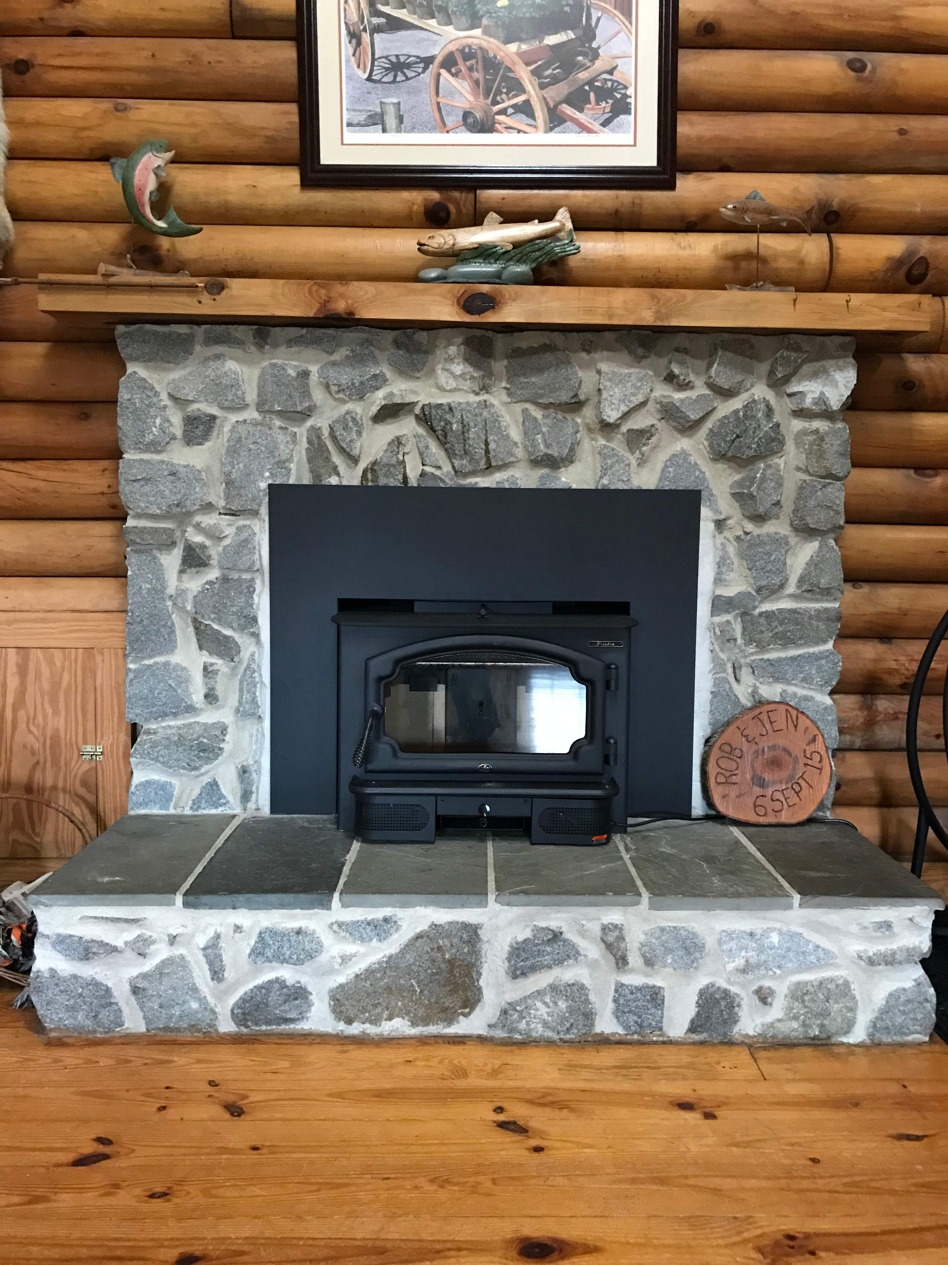 Wood Stove Insert + Stone + Mantel by Premier Chimney and Roofing
