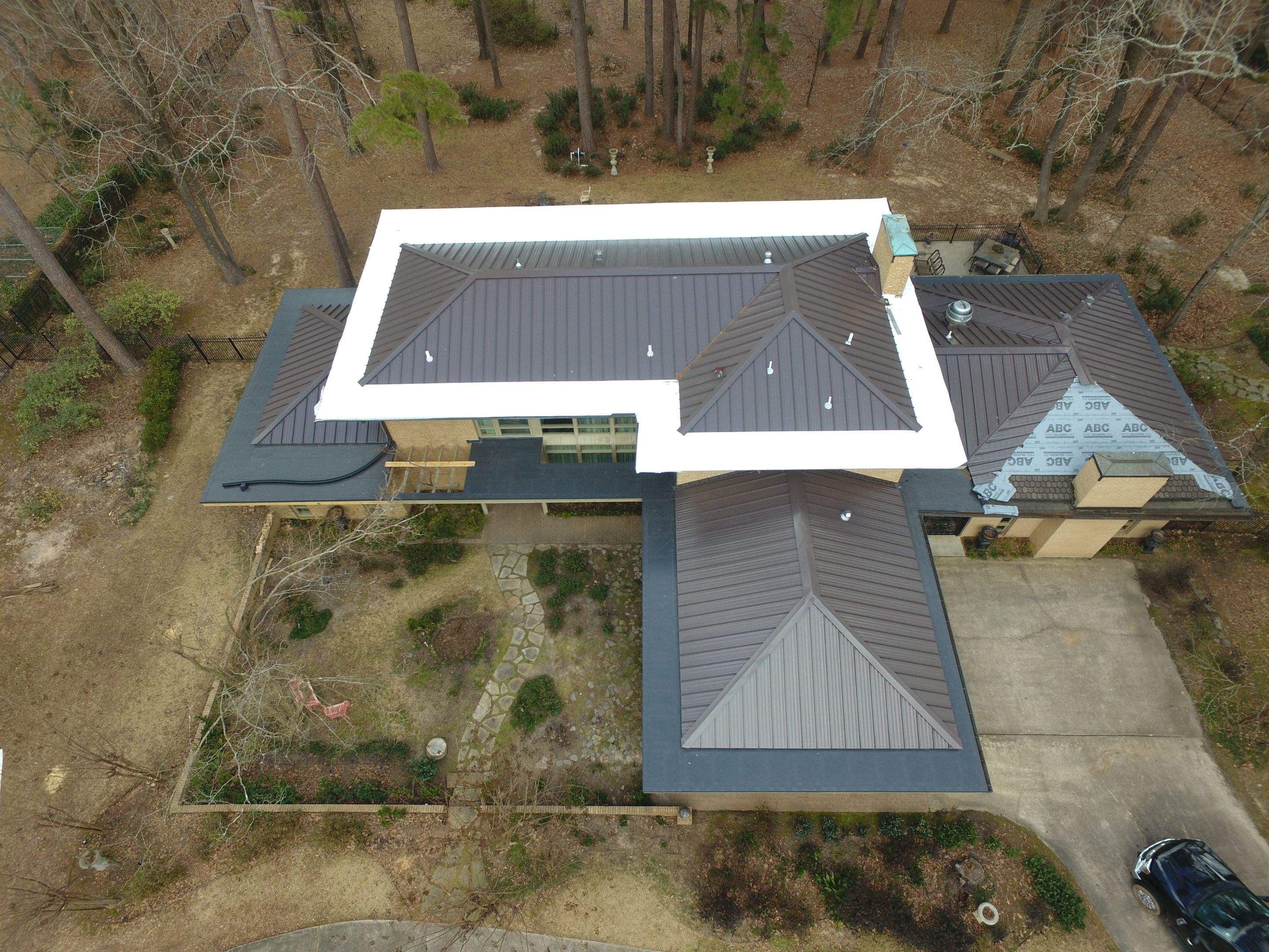 Residential Roofing Installation using PVC membrane and 24 gauge Standing Seam Metal by Hostetler Roofing
