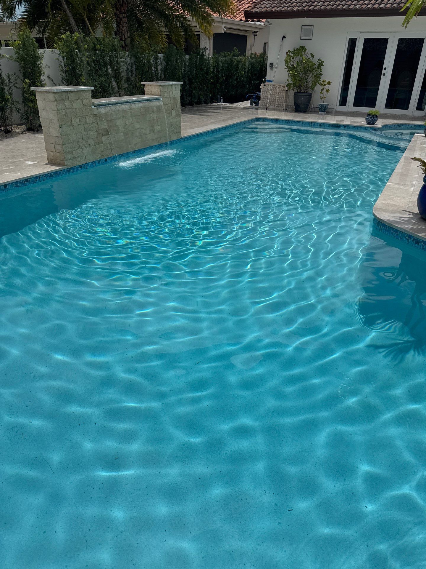 Watefall and bench addition by Pristine Pools Miami