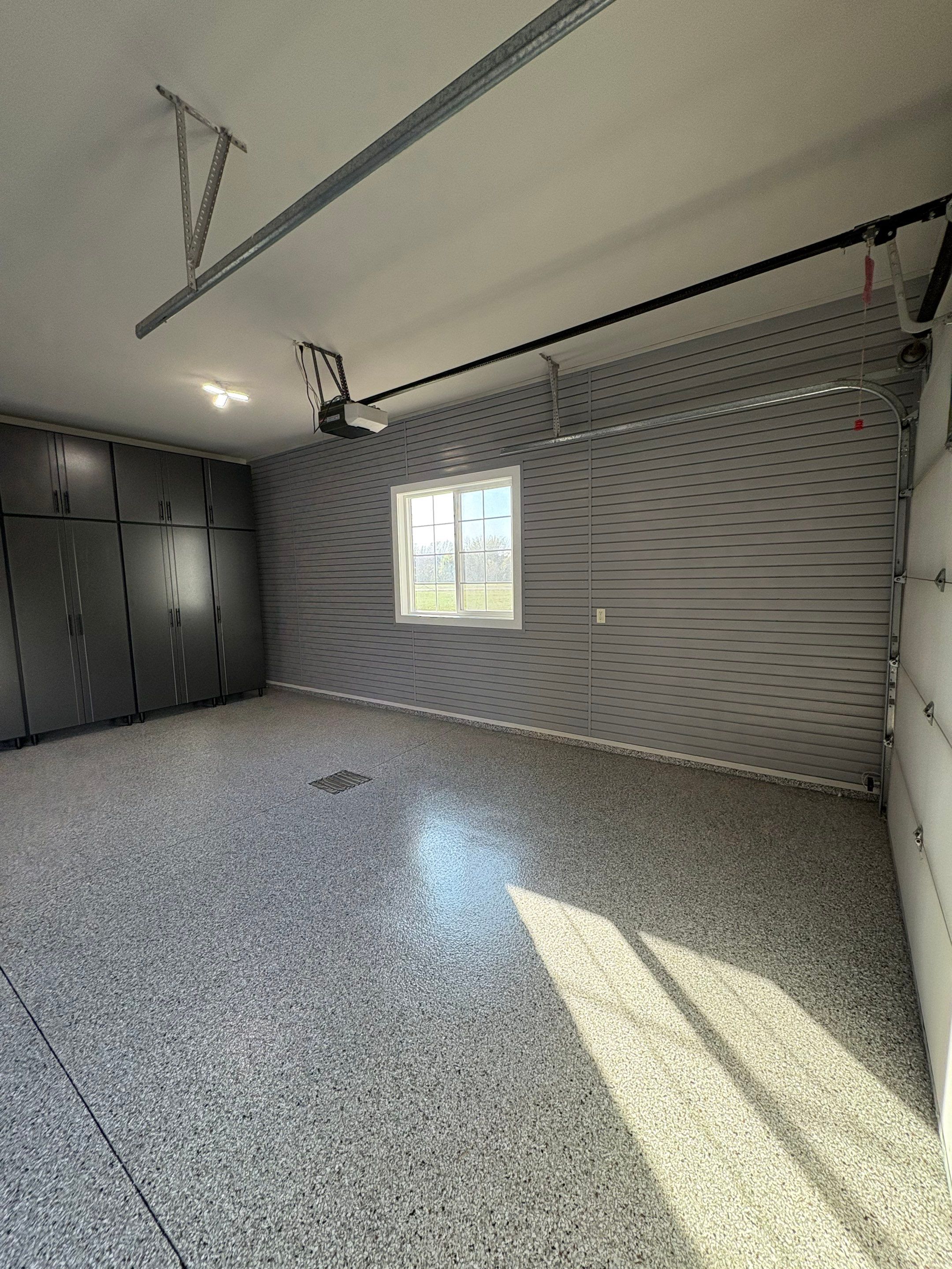 Yankton Garage Transformation with Dark Storage Cabinetry and Epoxy Flooring by Select Painting, Coatings & Garage Cabinets