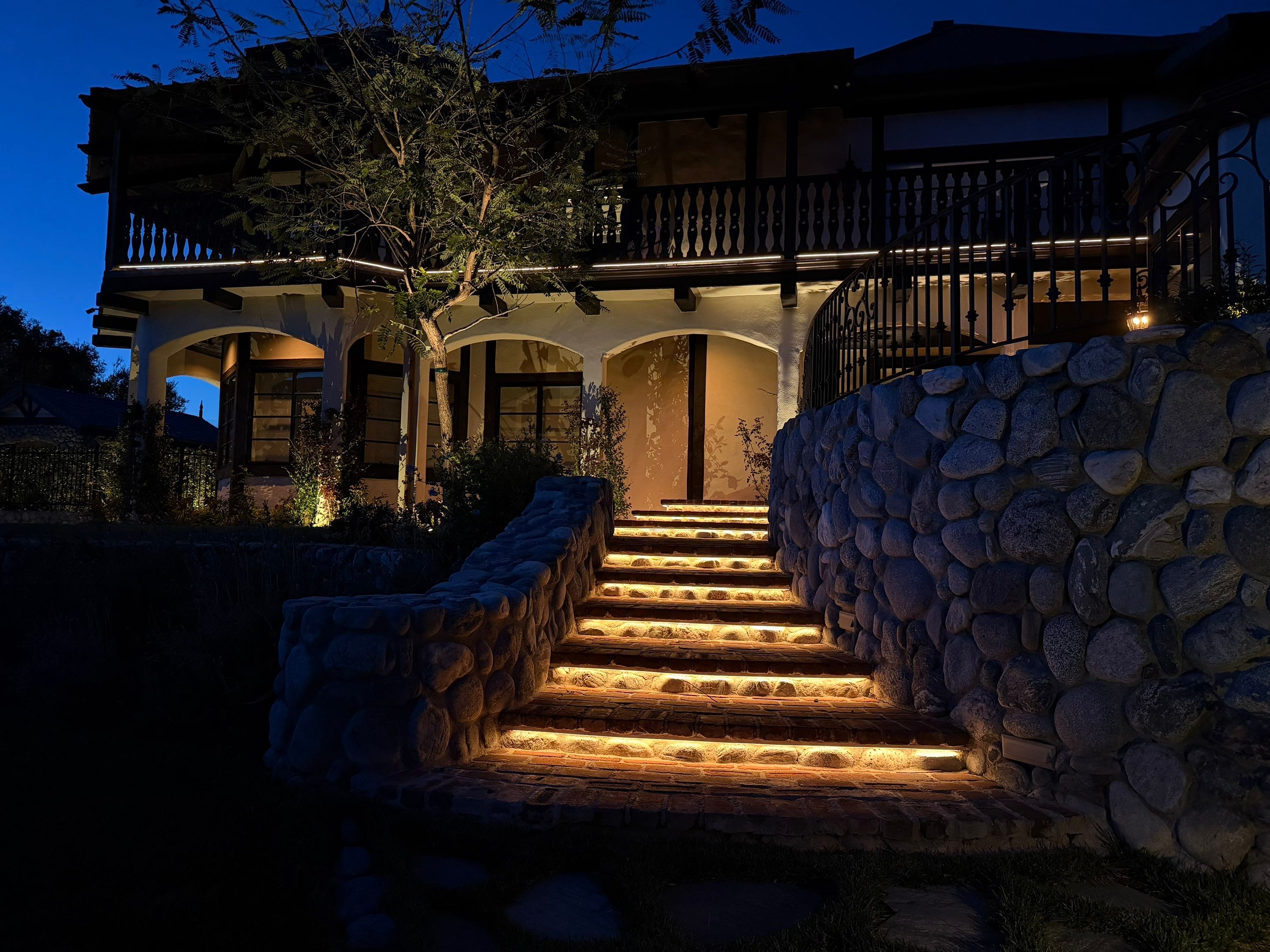 Tudor Estate Landscape Lighting with Integrated Stone Step Illumination by Outdoor Lights + Shades