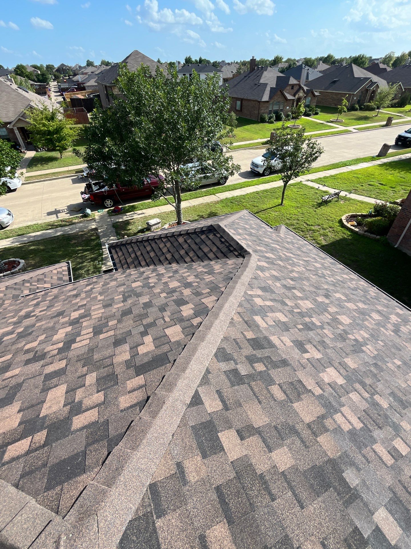 IKO Shadow Brown-Medium brown brick house by Tejas Roofworks + Restoration