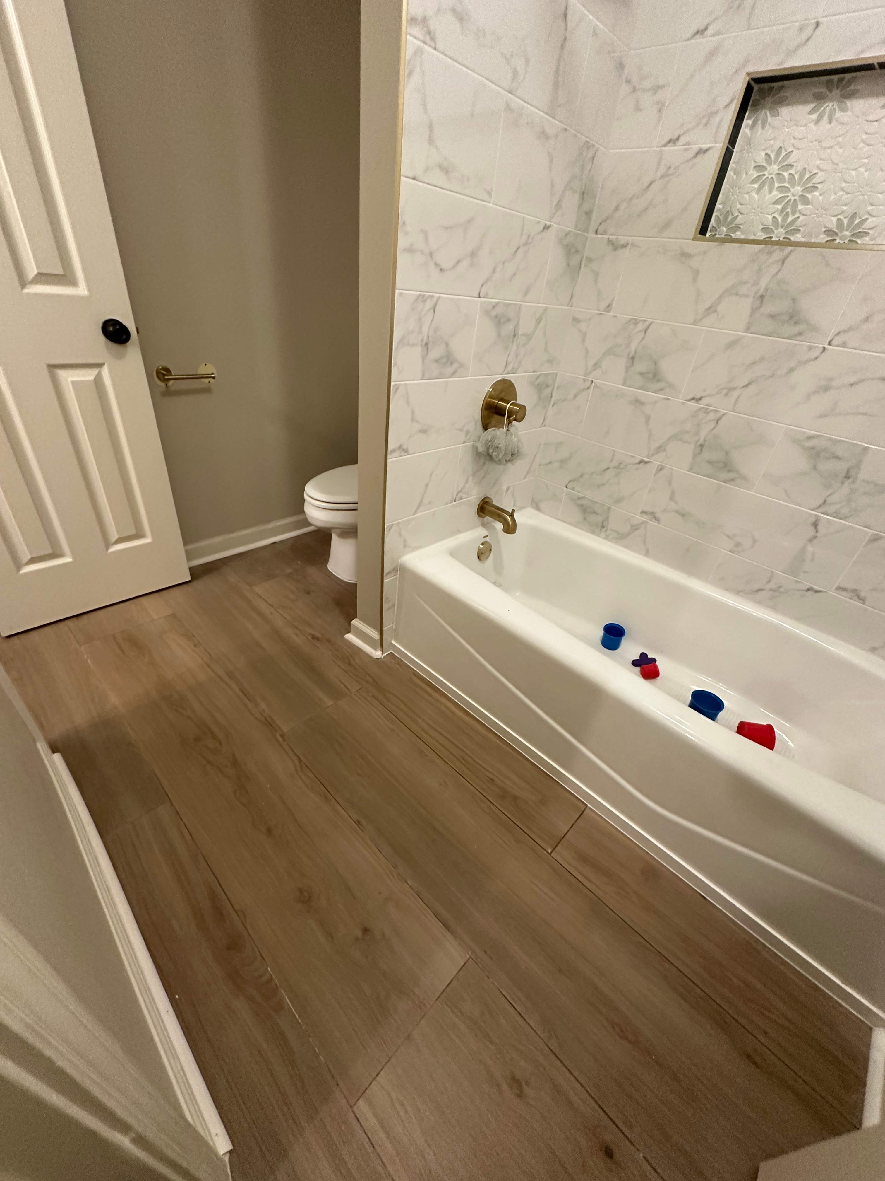 Tub retile, floor, vanities, mirror, and lights by Prudencio