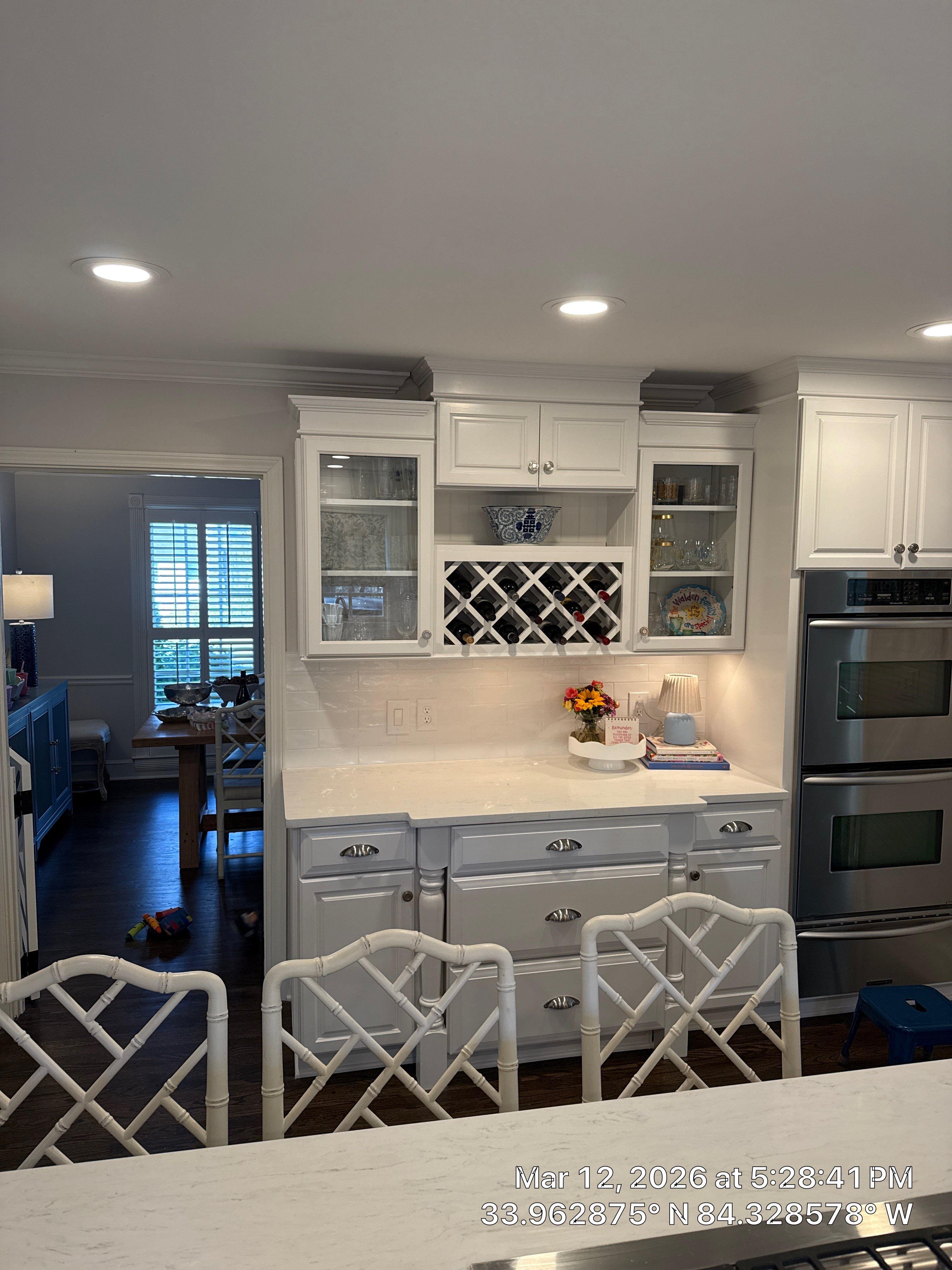 Kitchen Remodel in Dunwoody Featuring White Cabinetry and Blue Island by Heart & Home Kitchen & Bath Remodeling LLC